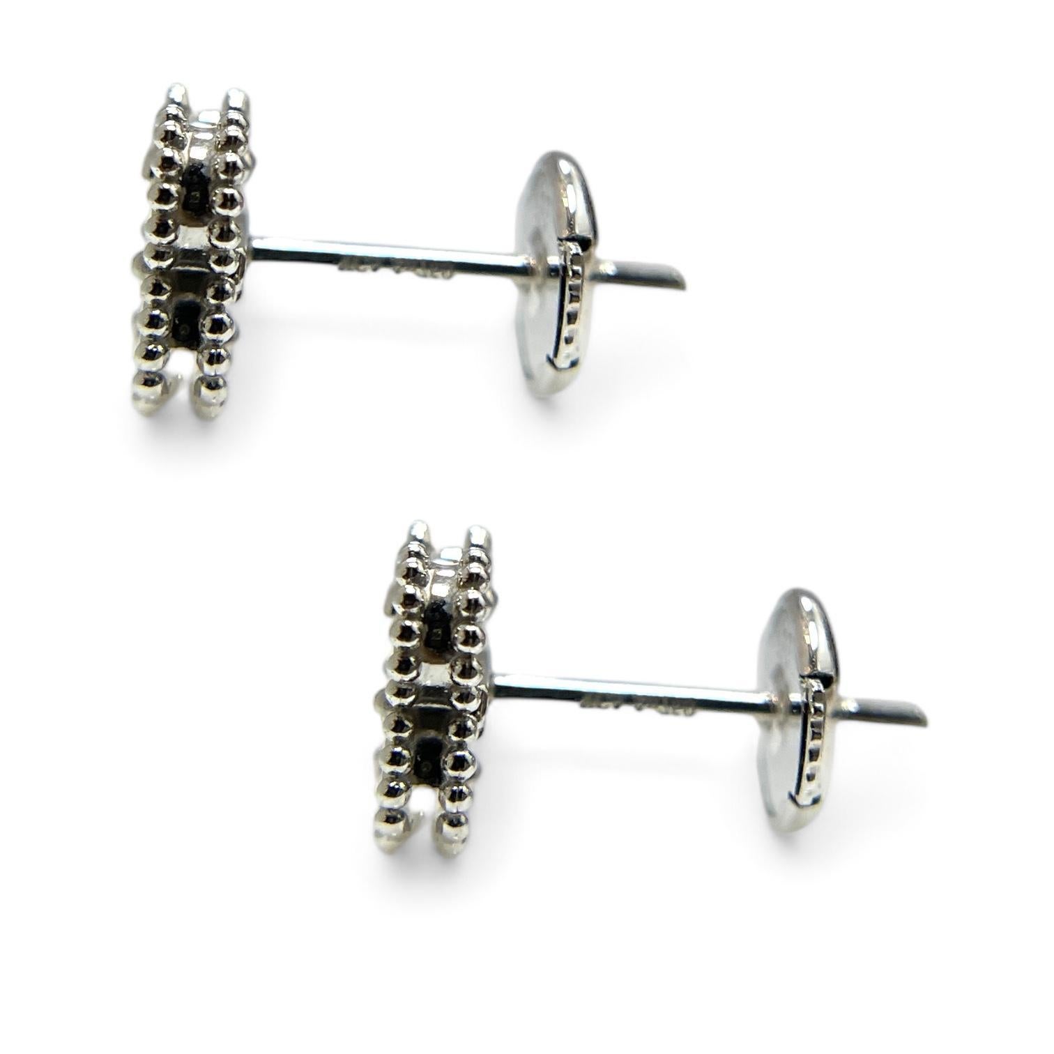 These exquisite 18K white gold VCA Sweet Alhambra ear studs showcase the beauty of mother of pearl, set in the signature clover design. A symbol of luck and elegance, these earrings add a touch of understated luxury to any ensemble. Ideal for those