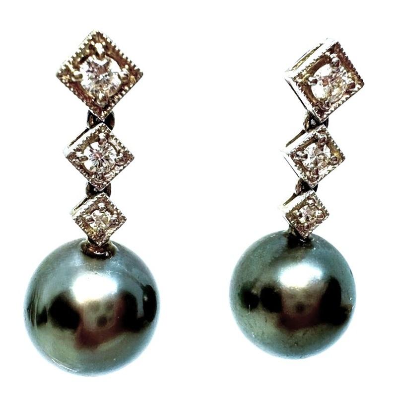 This pair of earrings is just so beautiful! and elegant!  They are .88 inch long and have 3 sparkly brilliant cut diamonds on each one.  The diamonds start at 2.0 and graduate downward to 1.5 mm and then 1 mm.  That totals .10 carats.  There is a