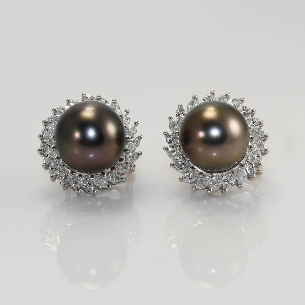 Ladies custom made Tahitian pearl and diamond earrings in 18k white gold settings.
Stamped 18k and weigh 15.9 grams gross weight.
The Tahitian pearls measure 12.5mm to 13mm, excellent luster.
On the sides are a halo of marquise shape diamonds, 3.00