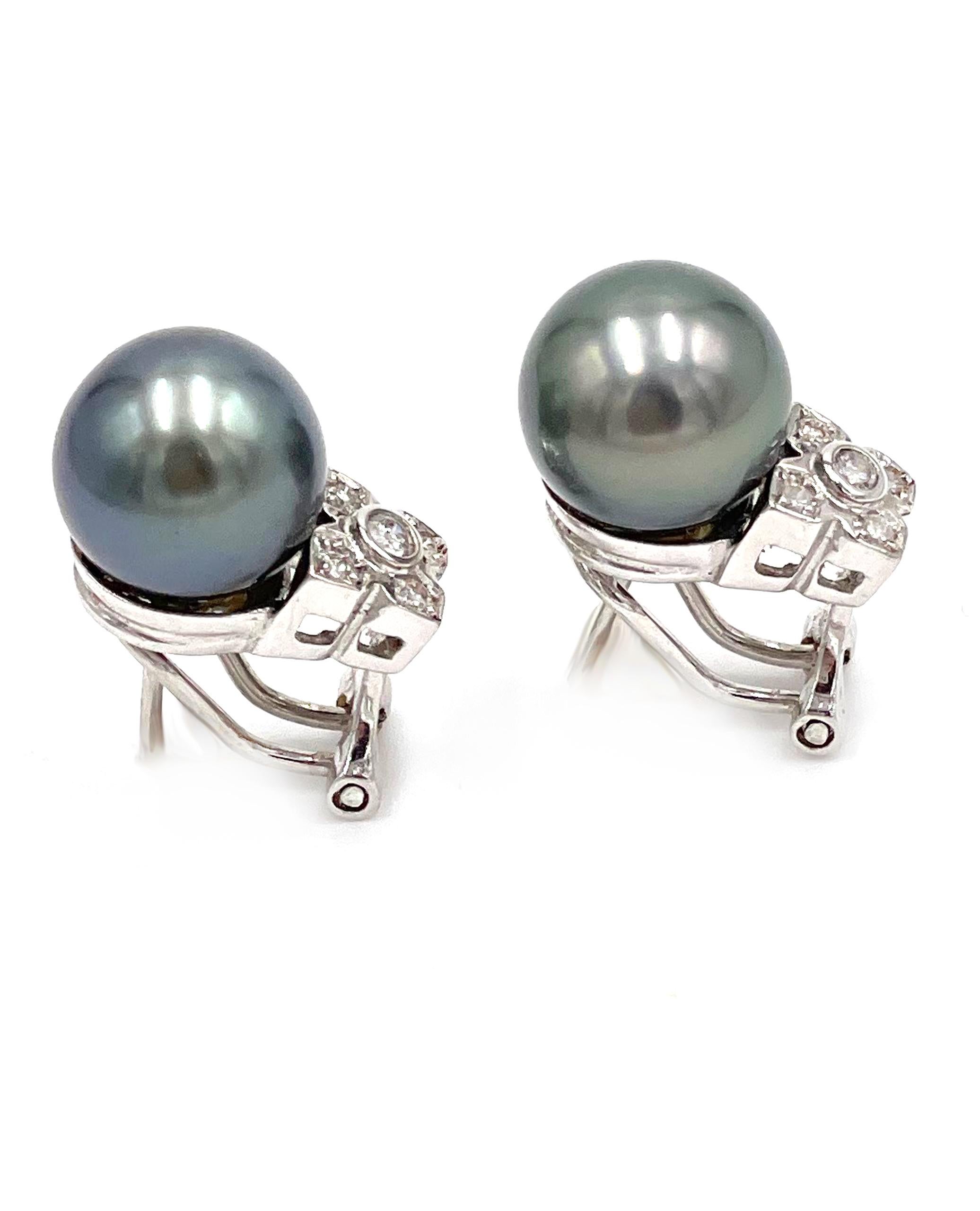 Pre owned pair of 18K white gold Tahitian South Sea pearl earrings with 10 round faceted diamonds weighing approximately 0.15 carats total.

* Omega back closure
* Diamonds are I color, SI2/ISI3 clarity.