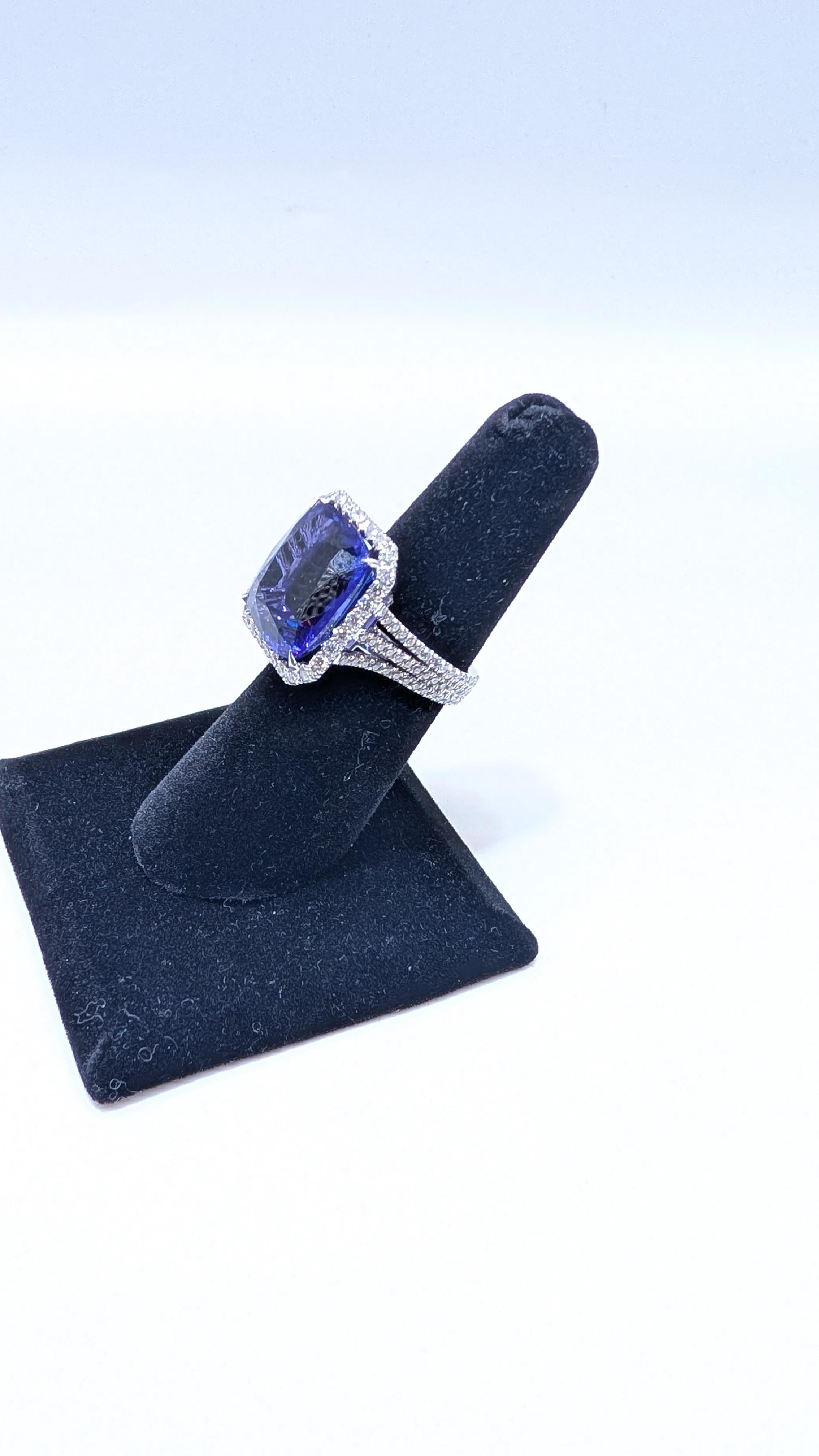 This breathtaking 18-karat white gold ring is the epitome of elegance and sophistication. At its heart lies a magnificent 16.05-carat tanzanite stone, captivating with its rich, deep blue-purple hue that shifts with the light. Surrounding the