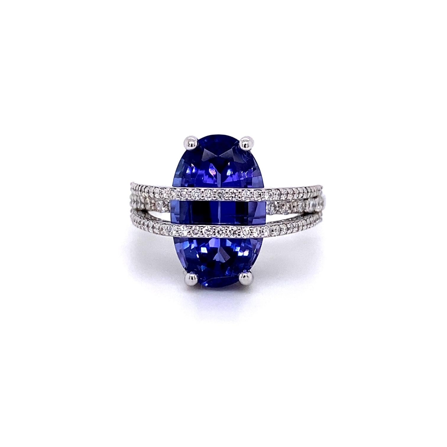 An 18k white gold ring set with one oval 6.05 carat tanzanite, and straps of .44 carats of white diamonds. Ring size 7, this ring was made and designed by llyn strong.