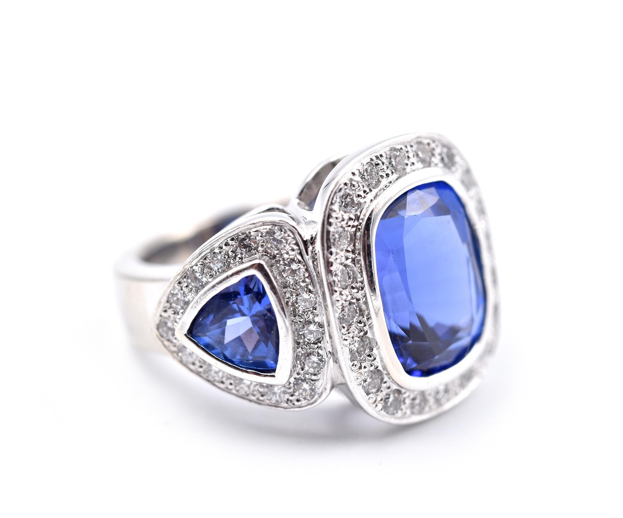 Designer: custom design
Material: 18k white gold
Tanzanite: 3 Tanzanite = 7.70cttw
Diamonds: 50 round brilliant cut = 1.50cttw
Color: G
Clarity: VS
Ring size: 6 (please allow two additional shipping days for sizing requests) 
Dimensions: Ring top is