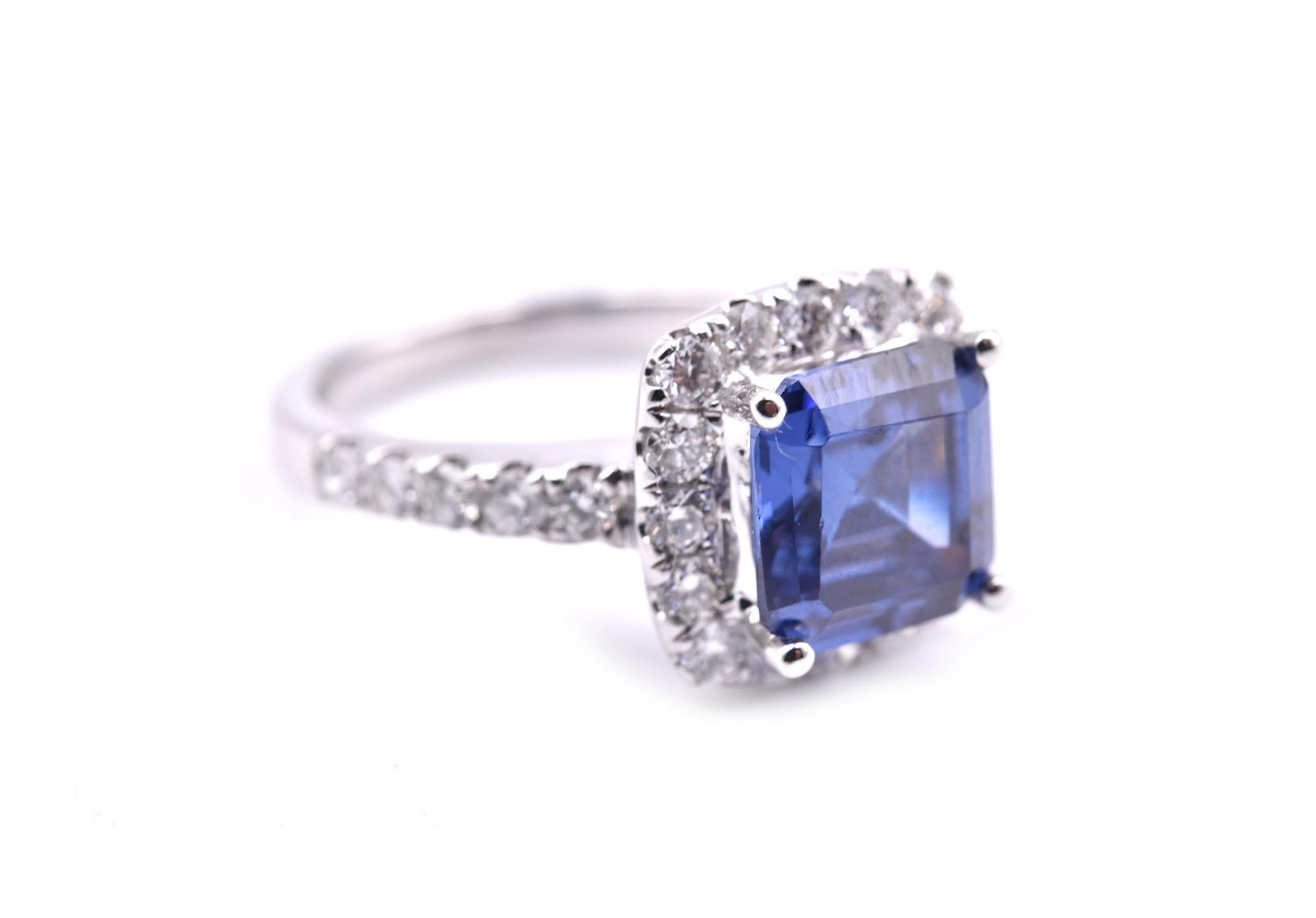 Designer: custom design
Material: 18k white gold 
Tanzanite: 1 round radiant cut= 4.30ct
Diamonds: 26 round brilliant cut= .81cttw
Color: G	
Clarity: VS
Ring Size: 6 ½ (please allow two additional shipping days for sizing requests)
Dimensions: ring