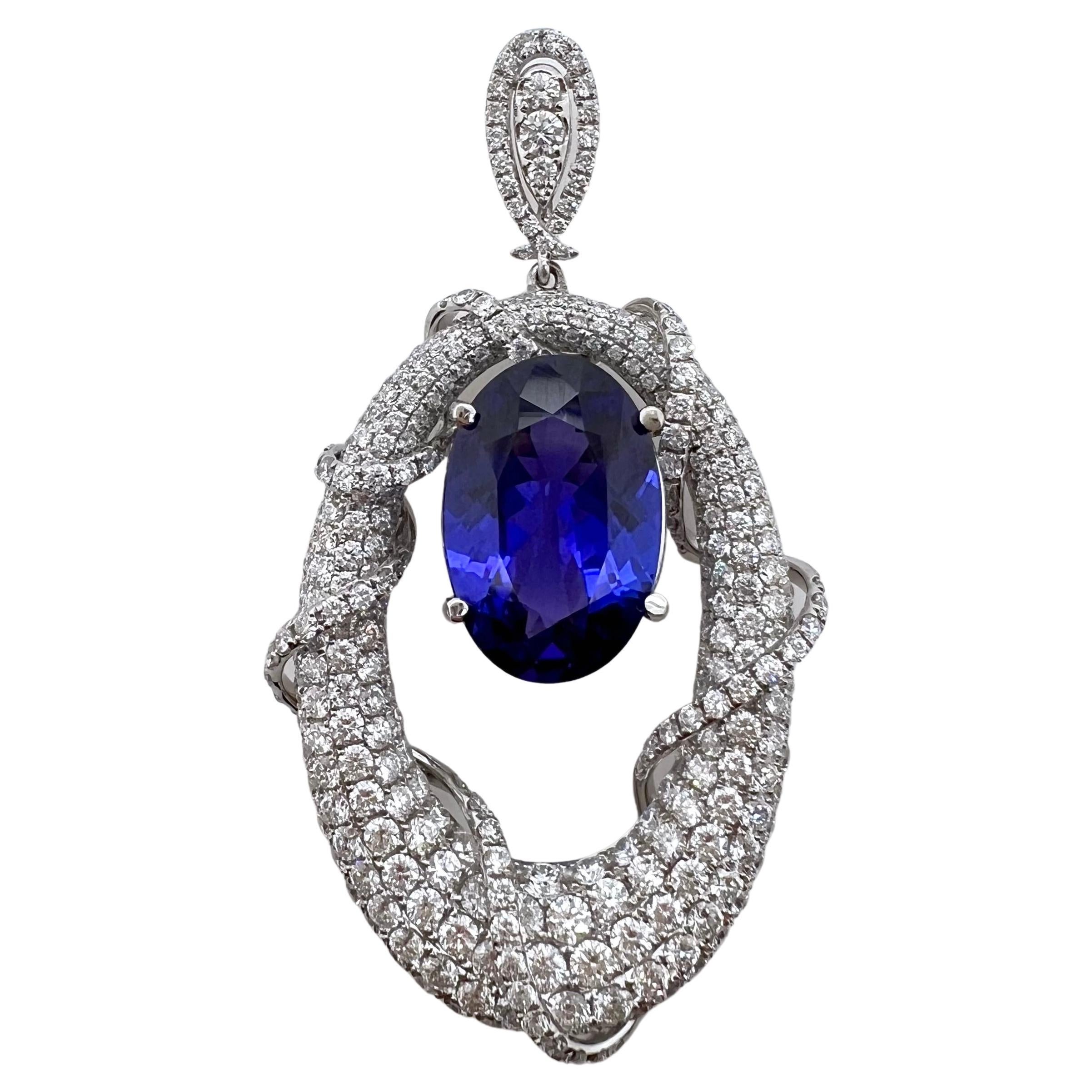 This contemporary tanzanite pendant will get everyone's attention.  The unique, modern design is astonishing and will be your favorite pendant.  The vibrant tanzanite has rich hues of purple and flashes of pink while the round brilliant diamonds are