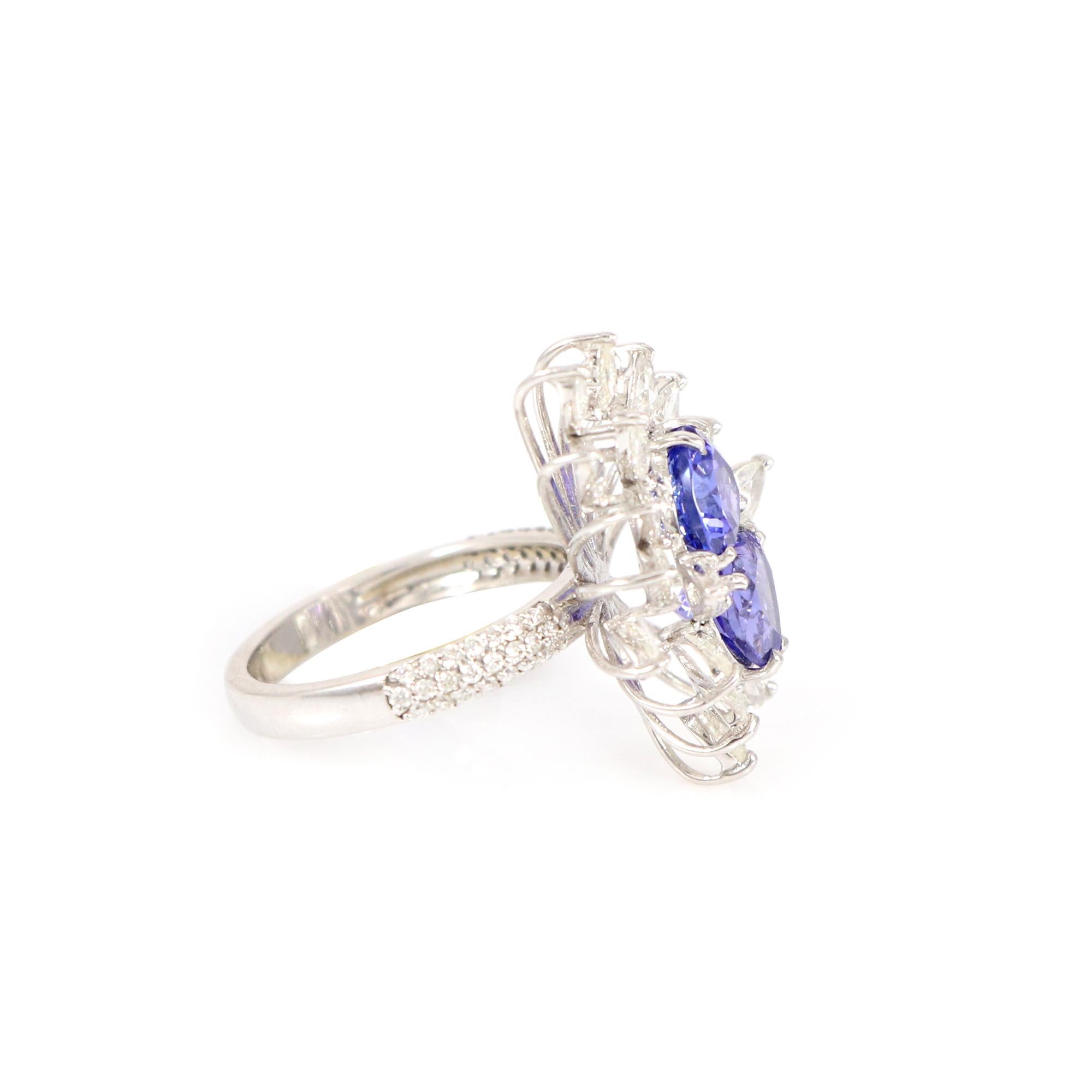 Discover our exquisite 18K white gold ring adorned with heart-shaped tanzanite and sparkling white diamonds. This piece embodies elegance and grace, blending the tanzanite's deep blue hue with the diamond's brilliance for luxury and sophistication.
