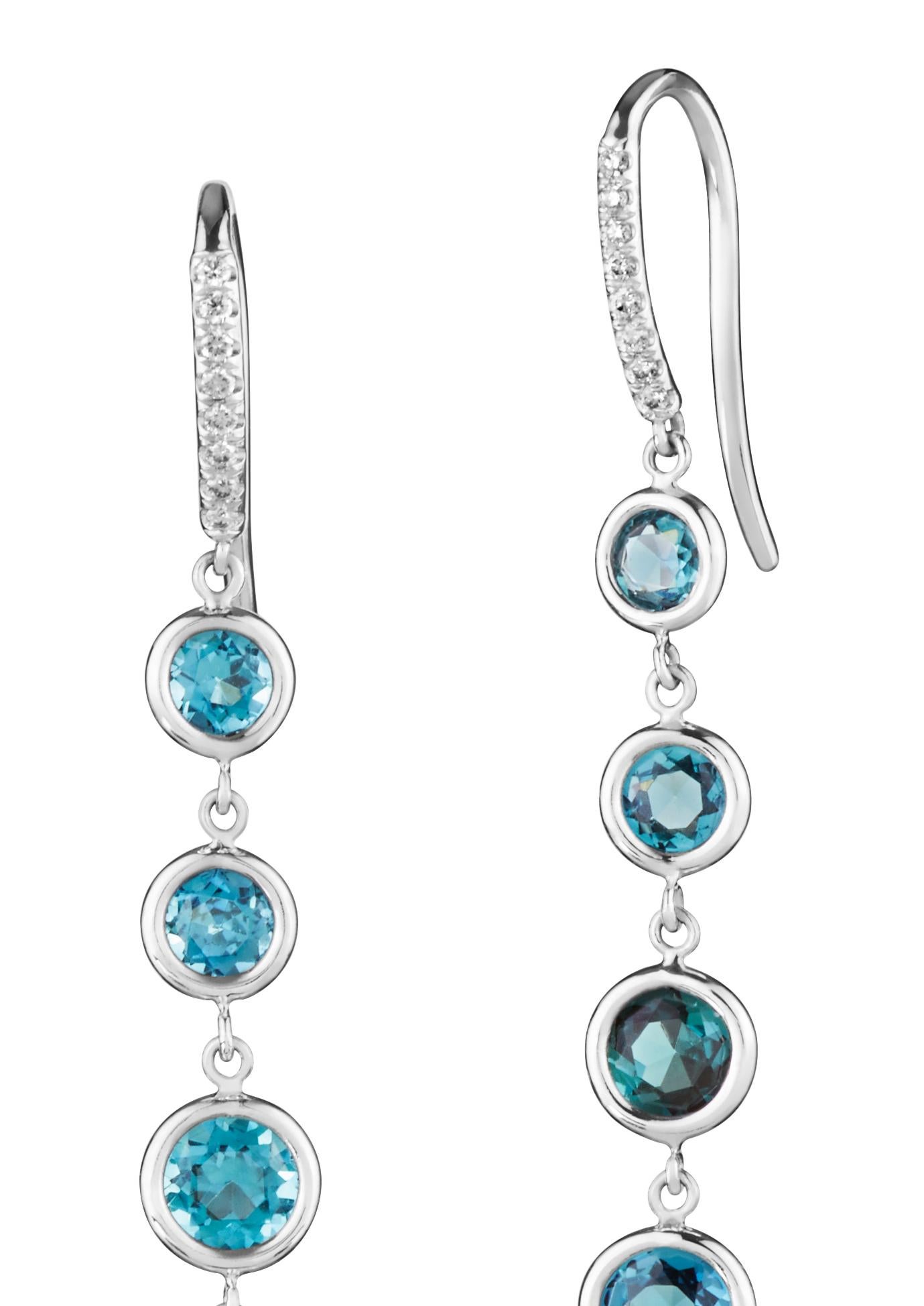 Stunning, long white gold and mixed natural green/blue tourmaline earrings. The hooks are accented with white pave diamonds. These earrings swing and move and are light as air.

18k white gold 
3.10 cts of tourmaline 
complimentary domestic ground
