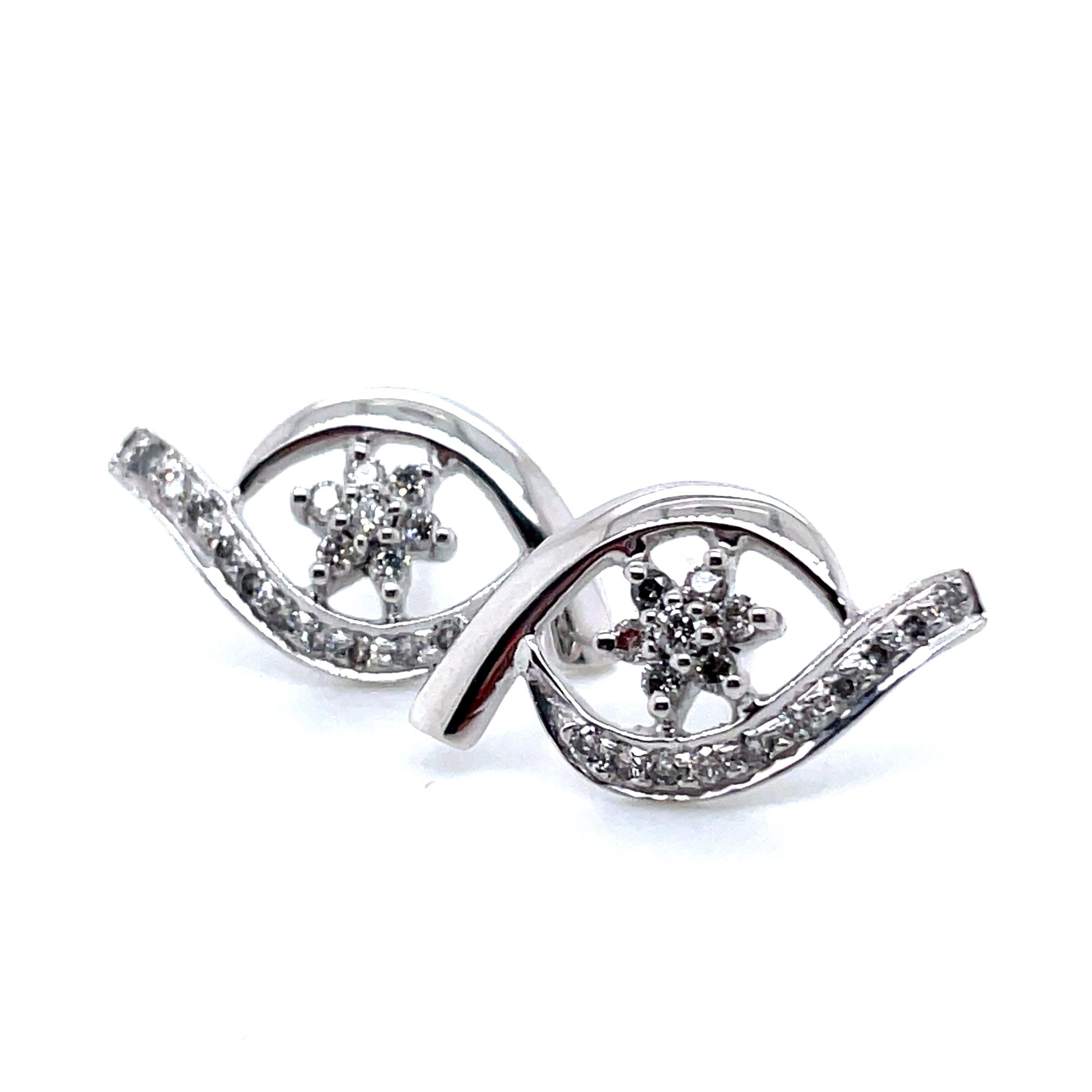 Dans le monde des boucles d'oreilles, ces merveilles en or blanc 18 carats sont un coup de pouce du destin à ne pas manquer. 

Leur design unique ajoute une touche ludique à l'élégance des diamants de 0,39 carat. 

La pureté de l'or 18 carats, qui