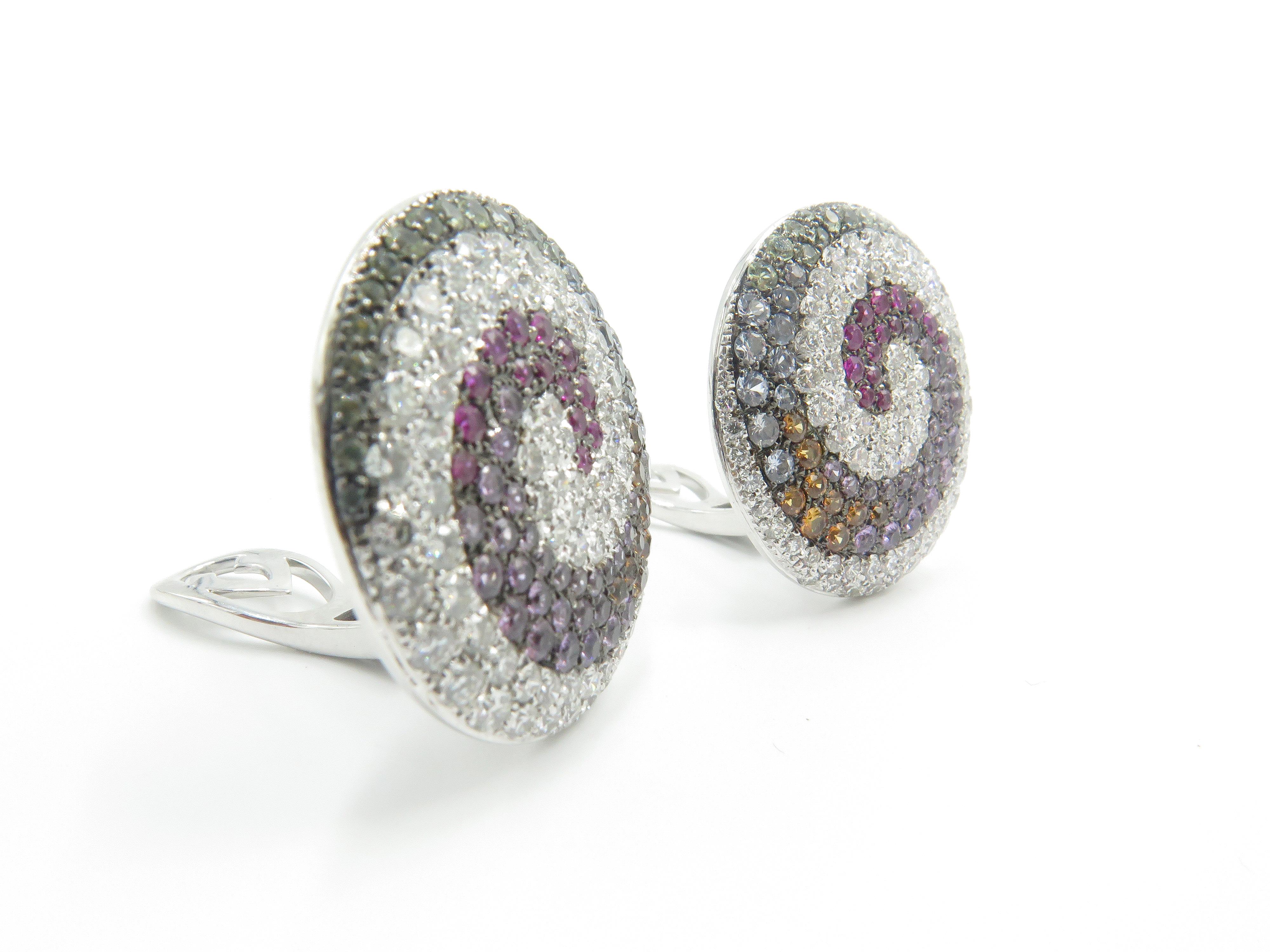 18K White Gold Valente Milano Swirl Earring with pave diamonds and multi-color sapphires. The fascinating arrangement of jewels that embellish the top of these fabulous earrings. A beautiful, set of earrings to go a long with the the gorgeous Ring &