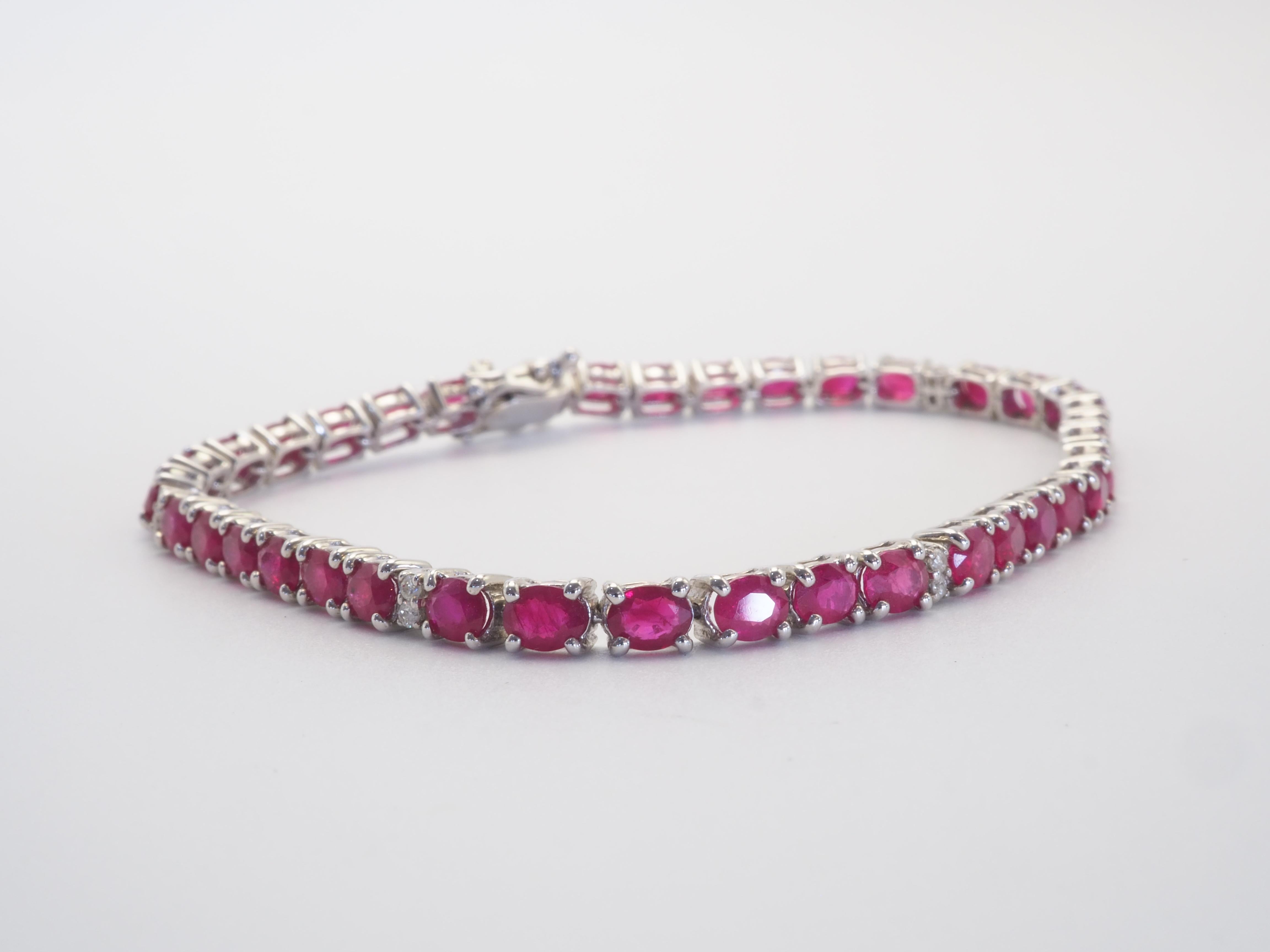 A very beautiful handmade tennis bracelet in 18K solid white gold with multiple oval cut red ruby stones weighting a total of 9.20 carats. The bracelet also includes gorgeous VS grade diamonds of total 12 pieces.  A very fine bracelet made with love