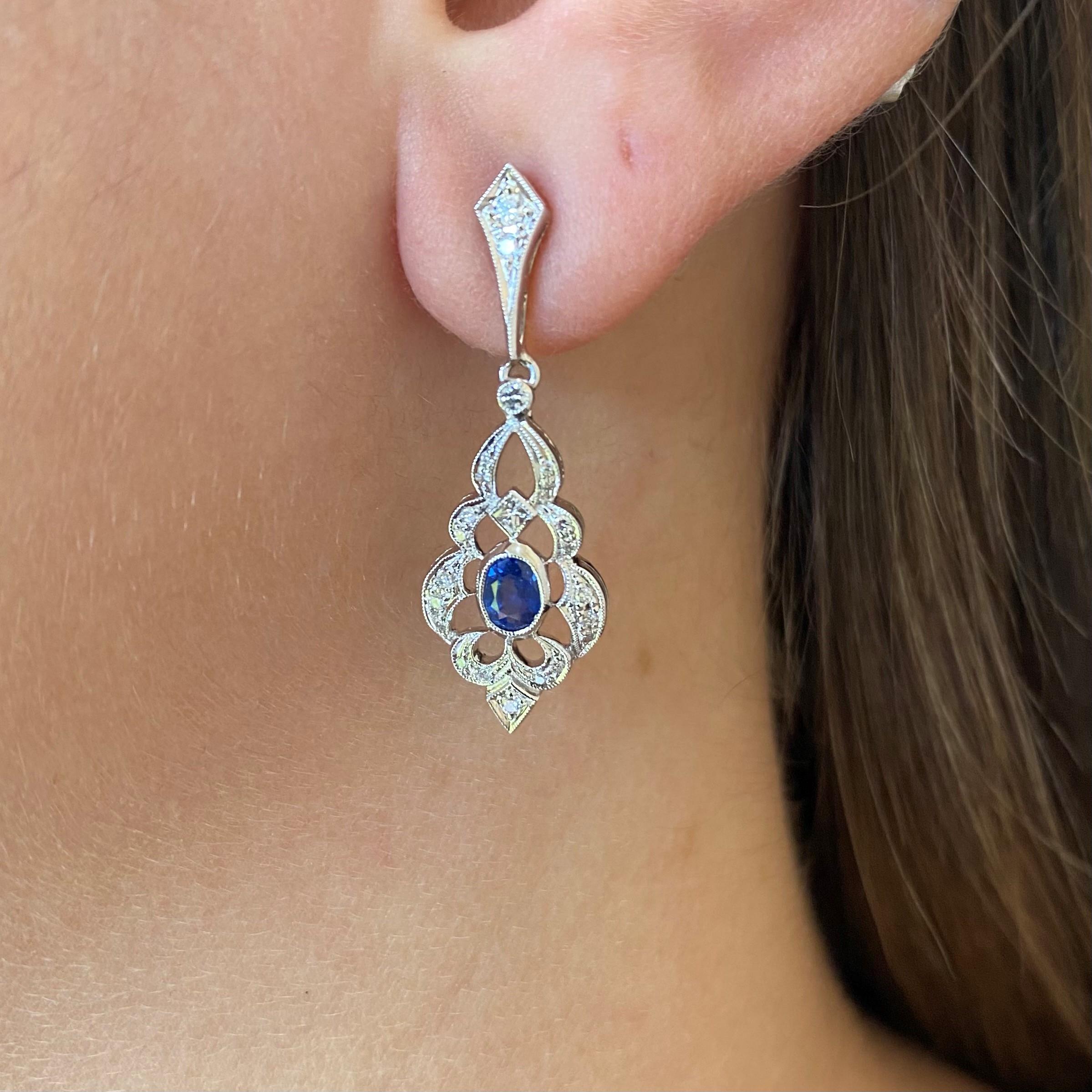 18k white gold vintage inspired drop earrings with two oval sapphires and diamond detail. Post back.


2 oval sapphires 0.66 carat total weight 
46 round brilliant 0.29 carat total weight H-I/VS-SI diamonds