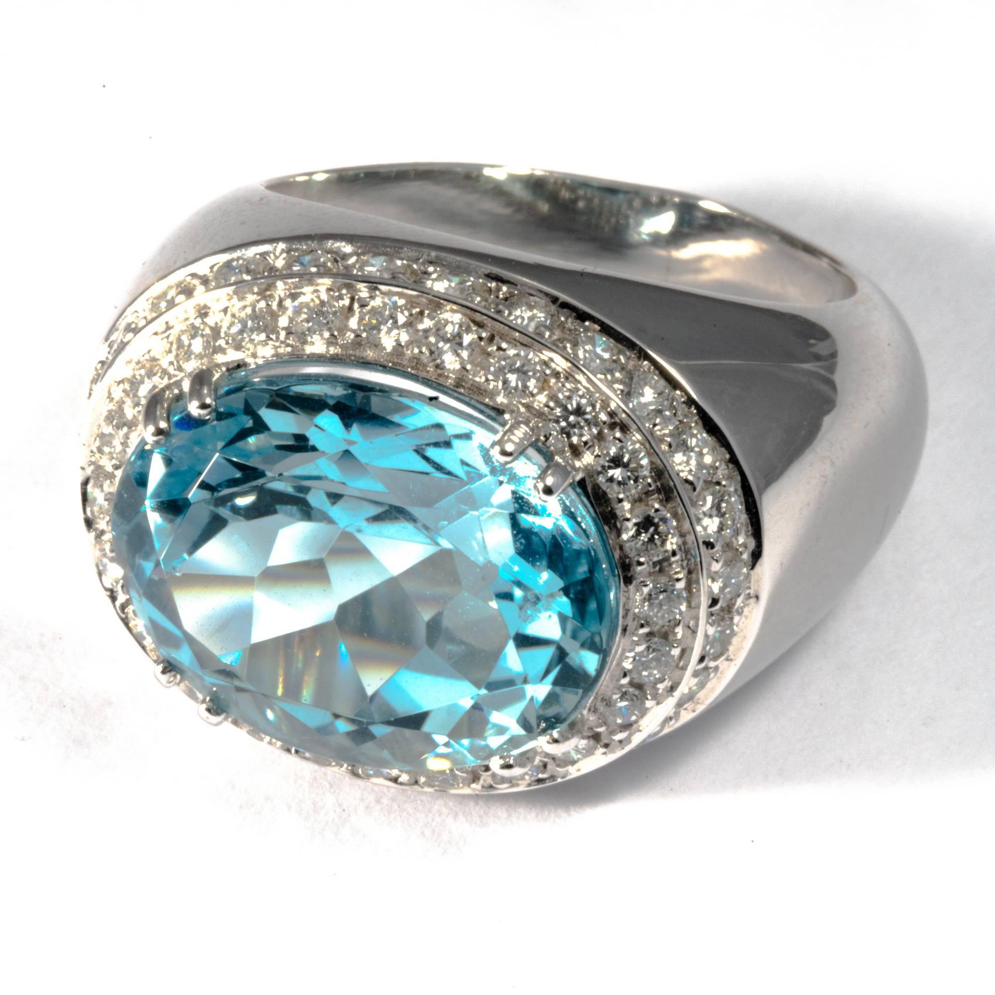 This stunning and mesmerizing large white gold cocktail ring will turn everybody's head! Elegant and playful,   it's lavish design puts the emphasis on the natural beauty of the gemstones. A rare vivid aquamarine of 10.10 carats sparkles at the