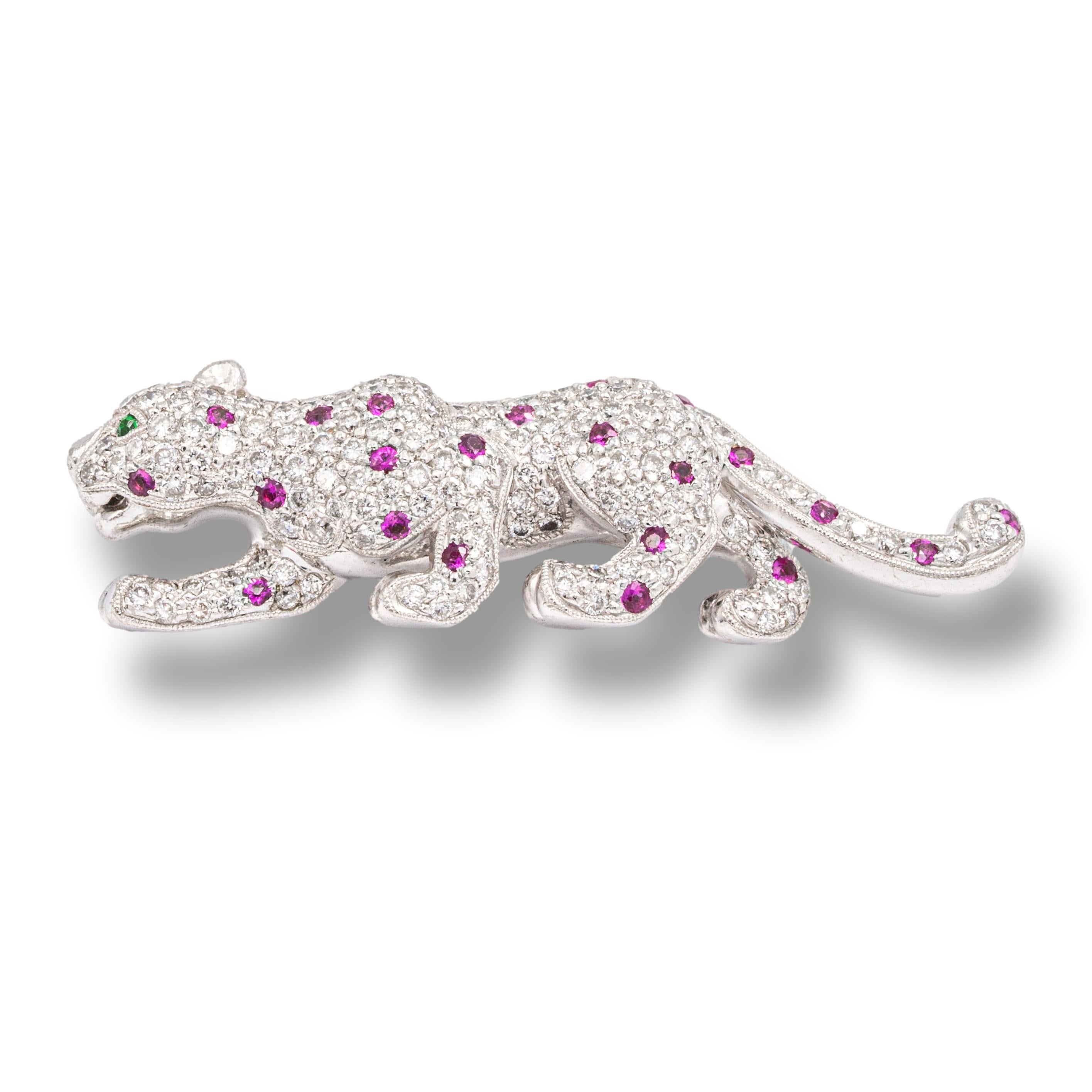 Vintage walking panther brooch finely crafted in 18 karat white gold with 123 round brilliant cut pave set diamonds weighing approximately 2.50 carats total weight, F-G Color VS-VVS Clarity and 22 pink sapphires weighing 0.44 carats total weight.