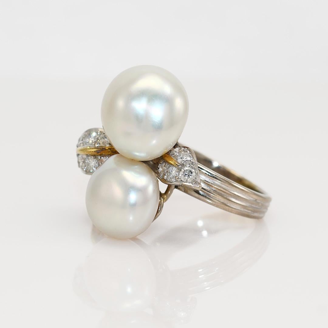 Ladies vintage pearl and diamond ring with 18k white gold setting.

Stamped 18k and weighs 11.7 grams gross weight.

The two baroque pearls are large freshwater type, excellent luster.

The side diamonds are round brilliant cuts, .75 total carats,