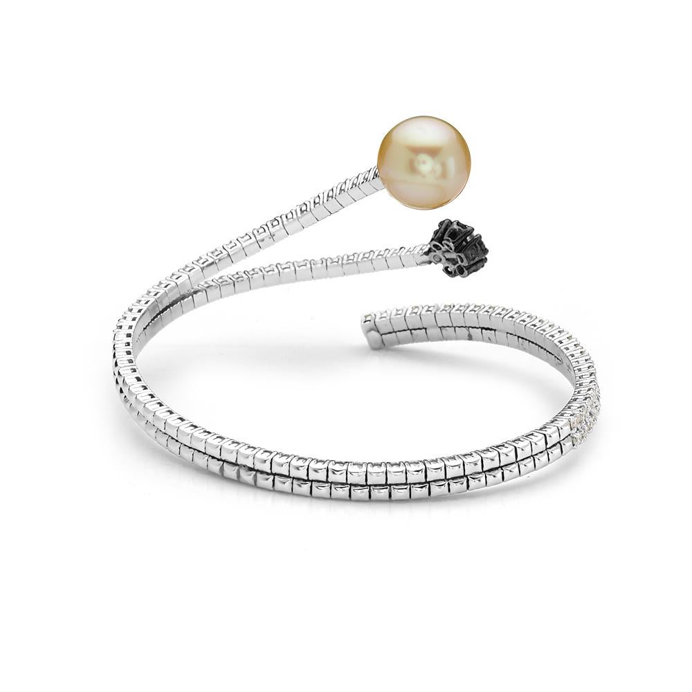 This 18K flexible wrap bracelet features 3.47 carats of white G VS and champagne diamonds and a 12mm pearl. 28 grams total weight. Made in Italy. 

Viewings available in our NYC showroom by appointment.
