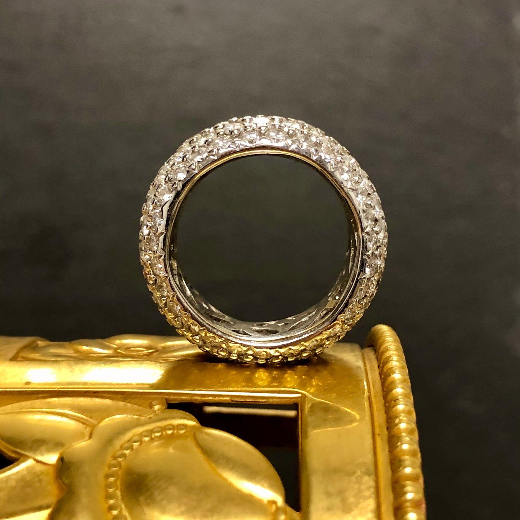 A fantastic wide band done in 18K white gold pavé set with larger diamonds all the way around and edge to edge. Total approximate diamond weight is 8.10cttw and all stones are G-I in color and Vs2-Si1 in clarity.

Dimensions/Weight
Measures 10.20mm