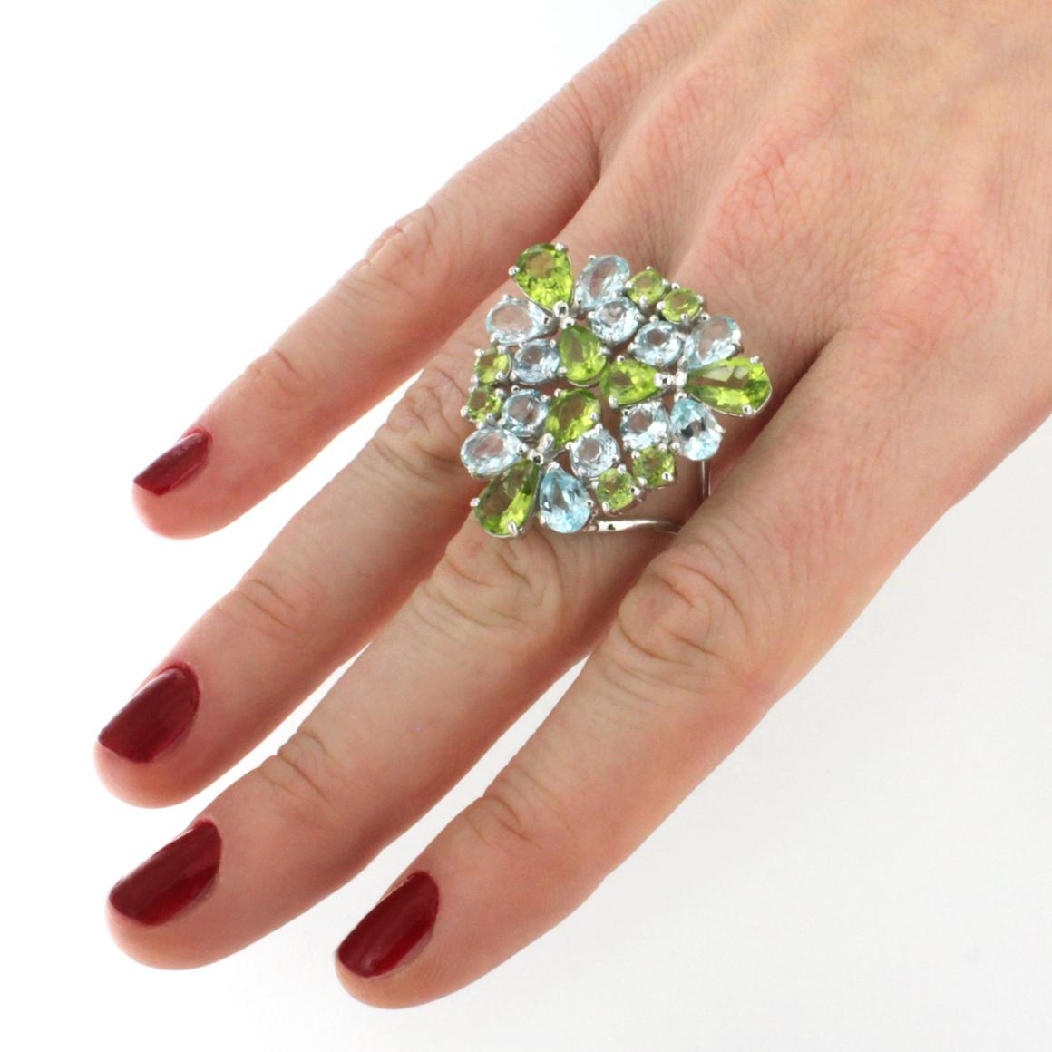 We love to transfer our passion to make you happy! Stunning Cocktail ring in 18k white gold with blue Topaz (drop cut, size:  mm, round cut, size: mm) and Peridot (drop cut, size:  mm, round cut, size: mm) made in Italy by Stanoppi jewellery since