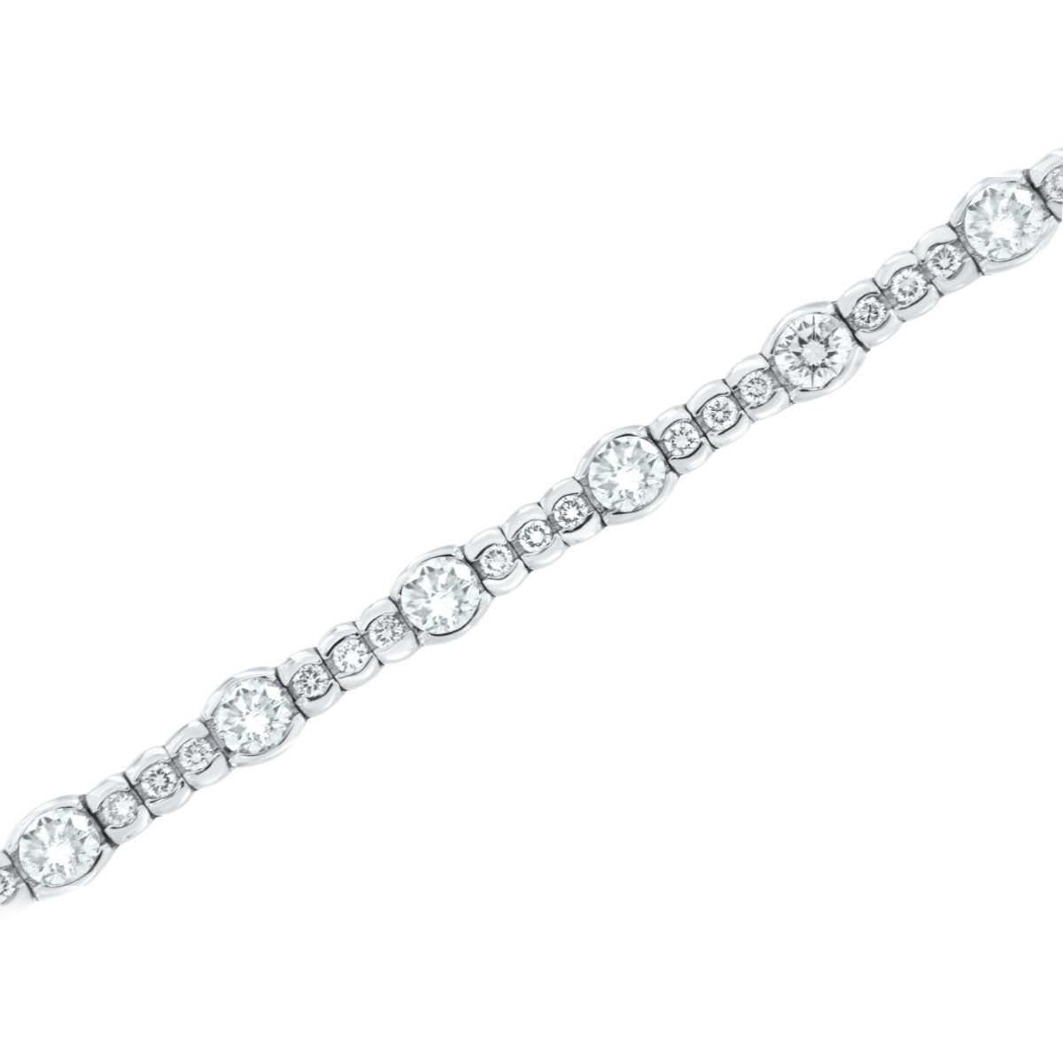 This stunning bracelet is a sixty-four ( 64) Round brilliant diamonds half bezel set for a weight of 5.93 Carat. Sixten (16) of the diamonds are 1/4 carat each ( 0.25 carat each), and forty-eight ( 48) of the diamonds are 0.04 carat each. 

Average
