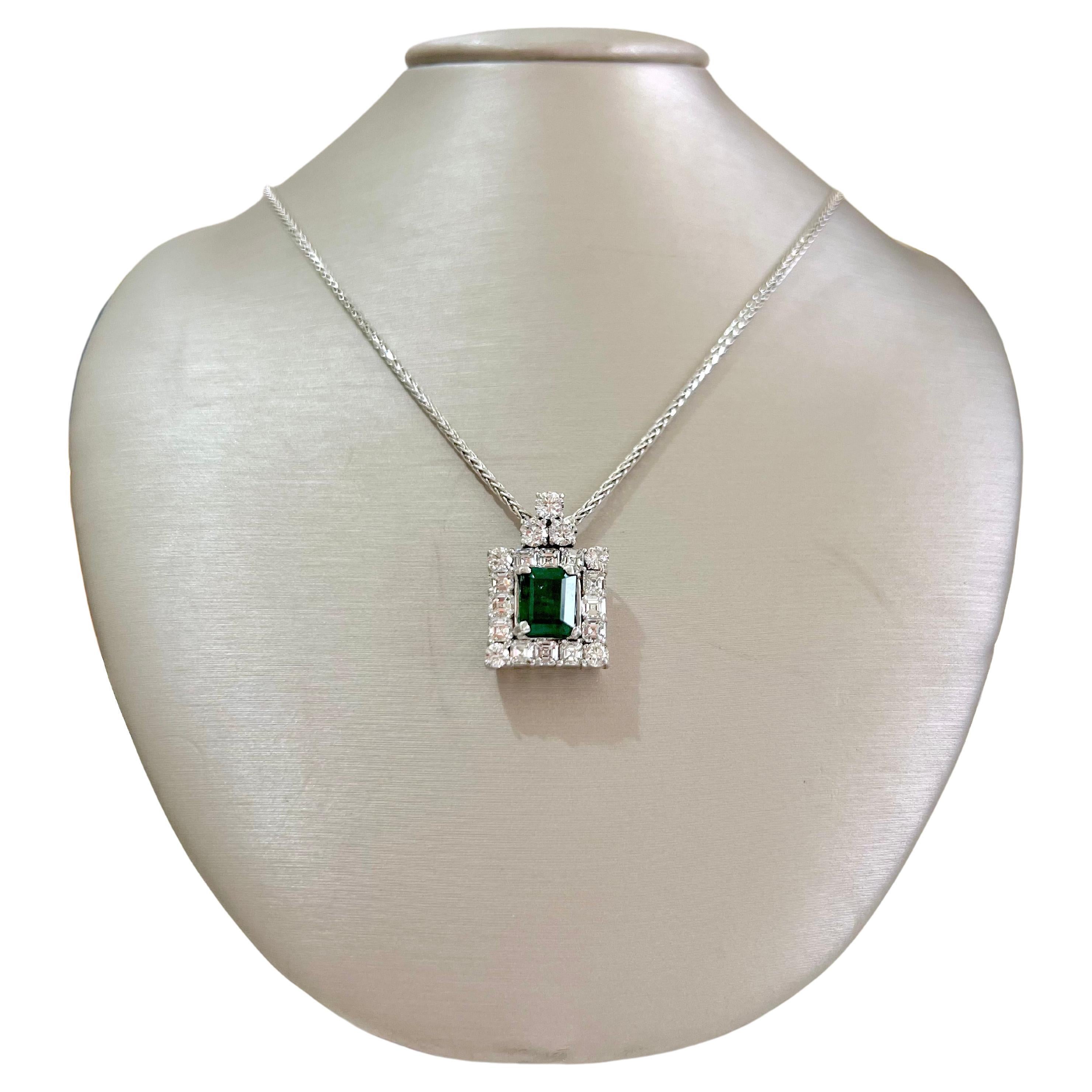 This stunning Zambian emerald is set in the middle of a custom made 18k white gold setting with gorgeous asscher cut diamonds and round brilliant diamonds.  The 4 round brilliant diamonds are strategically placed in the corners, while the asscher