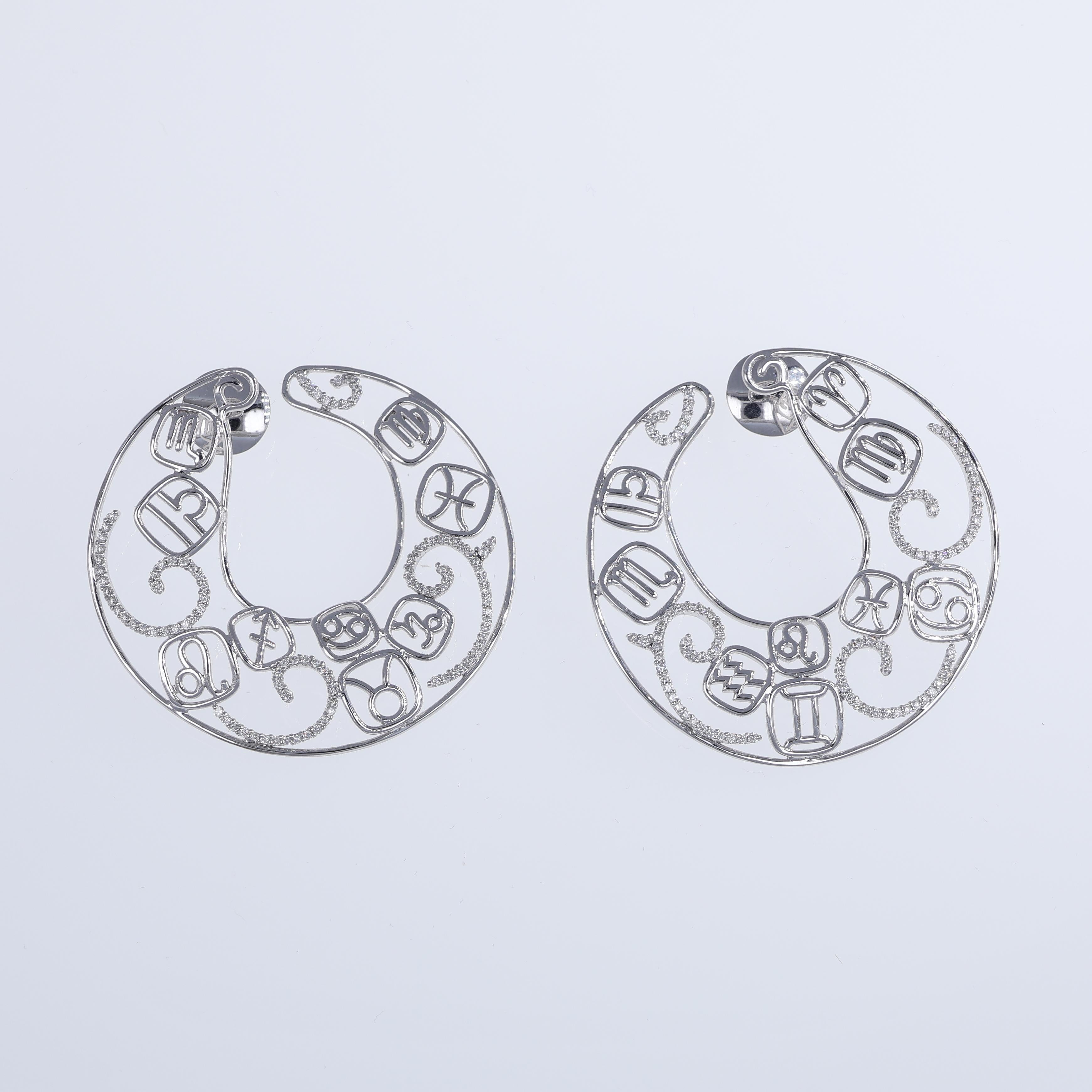 An exquisite pair of large round hoop earrings crafted in 18K white gold, featuring an intricate design of zodiac symbols adorned with brilliant-cut diamonds. With a total diamond weight of 1.16 carats, these earrings offer a dazzling sparkle and a