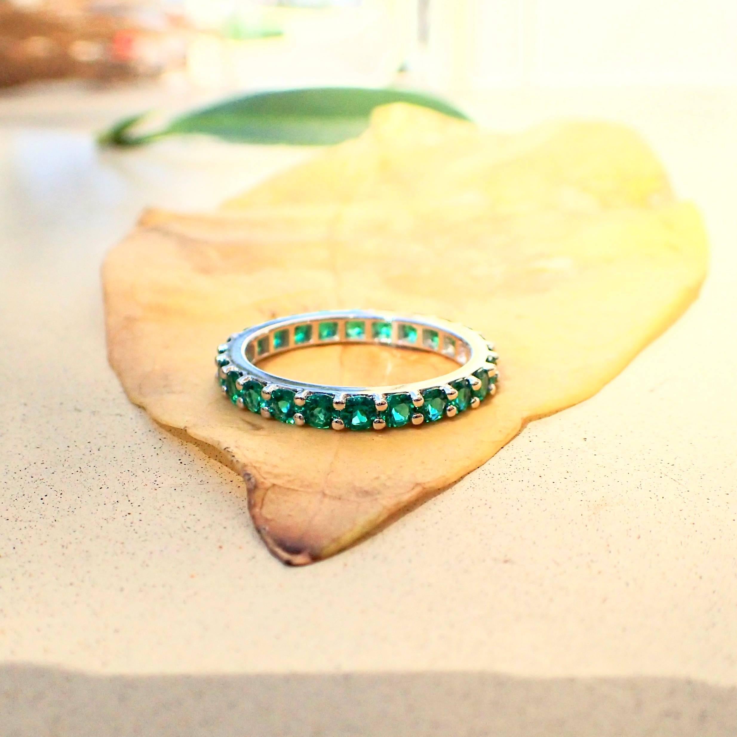 Round Cut 18 Karat Gold Eternity Band with Chatham-Created Emeralds Weighing 1.22 Carat