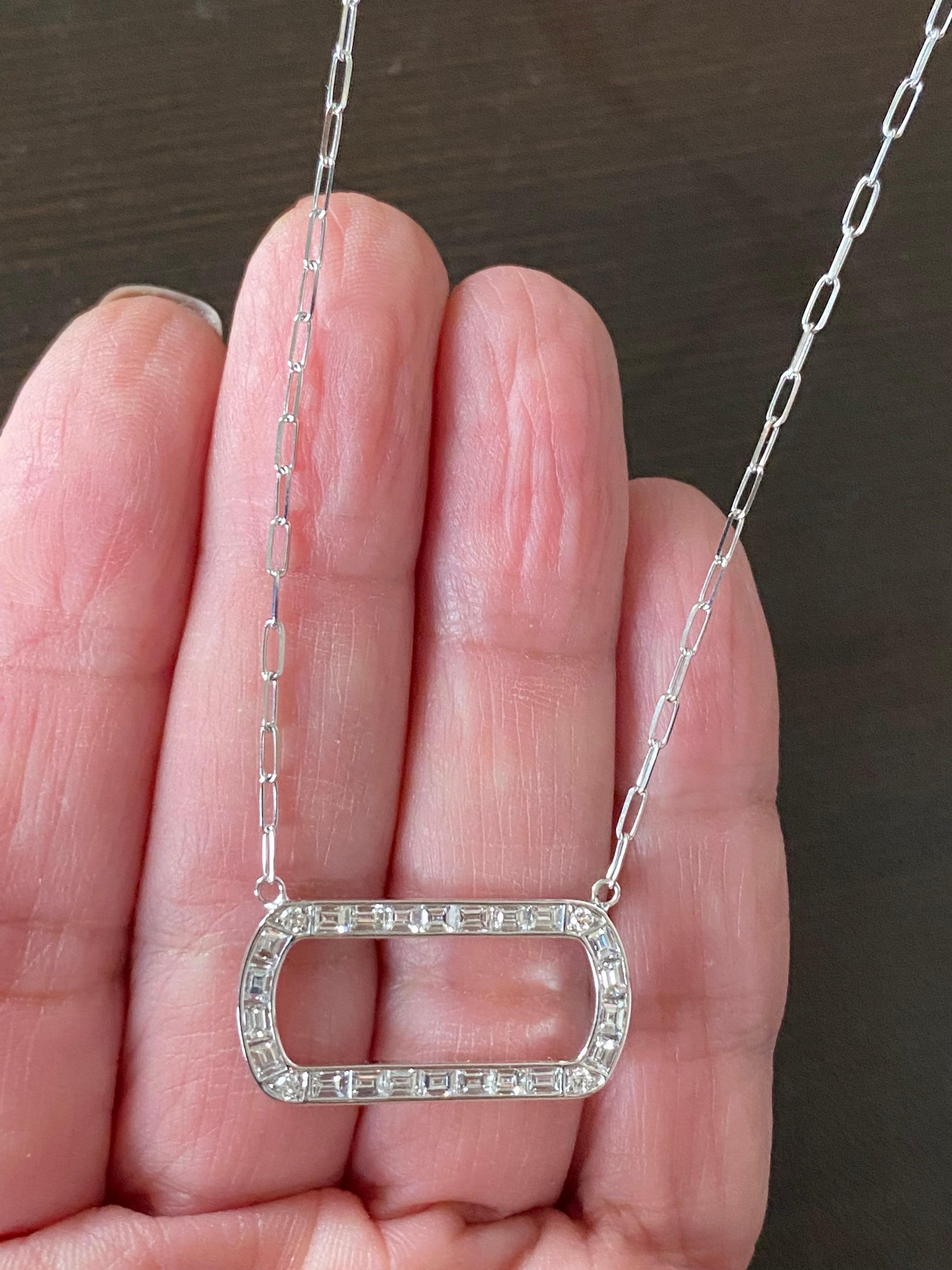 Horizontal diamond pendant set with baguette stones. 4 Round diamonds are set in each corner. The pendant is also made in a vertical style. The pendant is set in 18K white gold. The color of the stones are F, the clarity is VS1-VS2. The carat weight