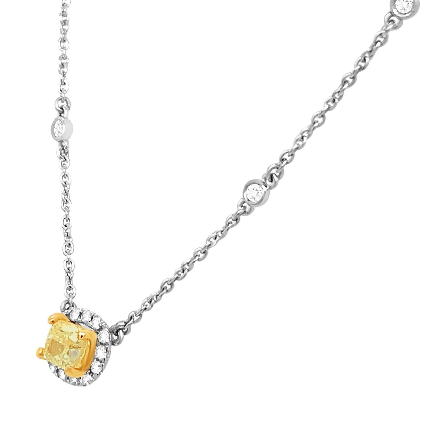 This stunning 18k white and yellow gold necklace features a 0.51 Carat Yellow Elongated cushion-shaped diamond encircled by one row of brilliant round diamonds on a 1 mm station chain containing sixteen (16) round brilliant diamonds bezel set.
The