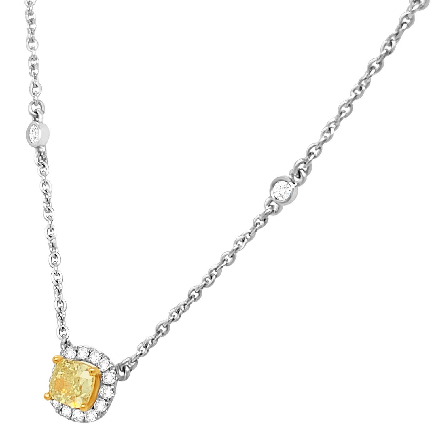 This stunning 18k White gold and Yellow gold necklace feature a 0.52 Carat Yellow Elongated cushion-shaped diamond encircled by one row of brilliant round diamonds on a 1 mm station chain containing sixteen (16) round brilliant diamonds bezel