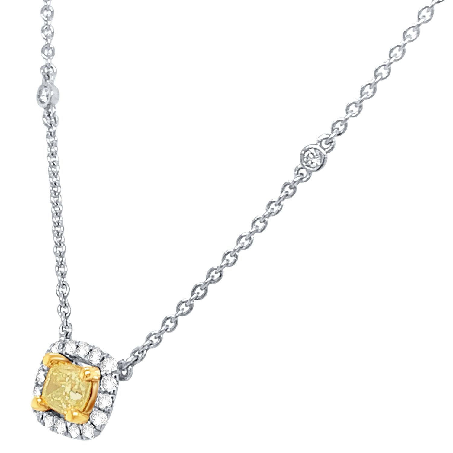 This stunning 18k White gold and Yellow gold necklace feature a 0.55 Carat Yellow Elongated cushion-shaped diamond encircled by one row of brilliant round diamonds on a 1 mm station chain containing fourteen (14) round brilliant diamonds bezel