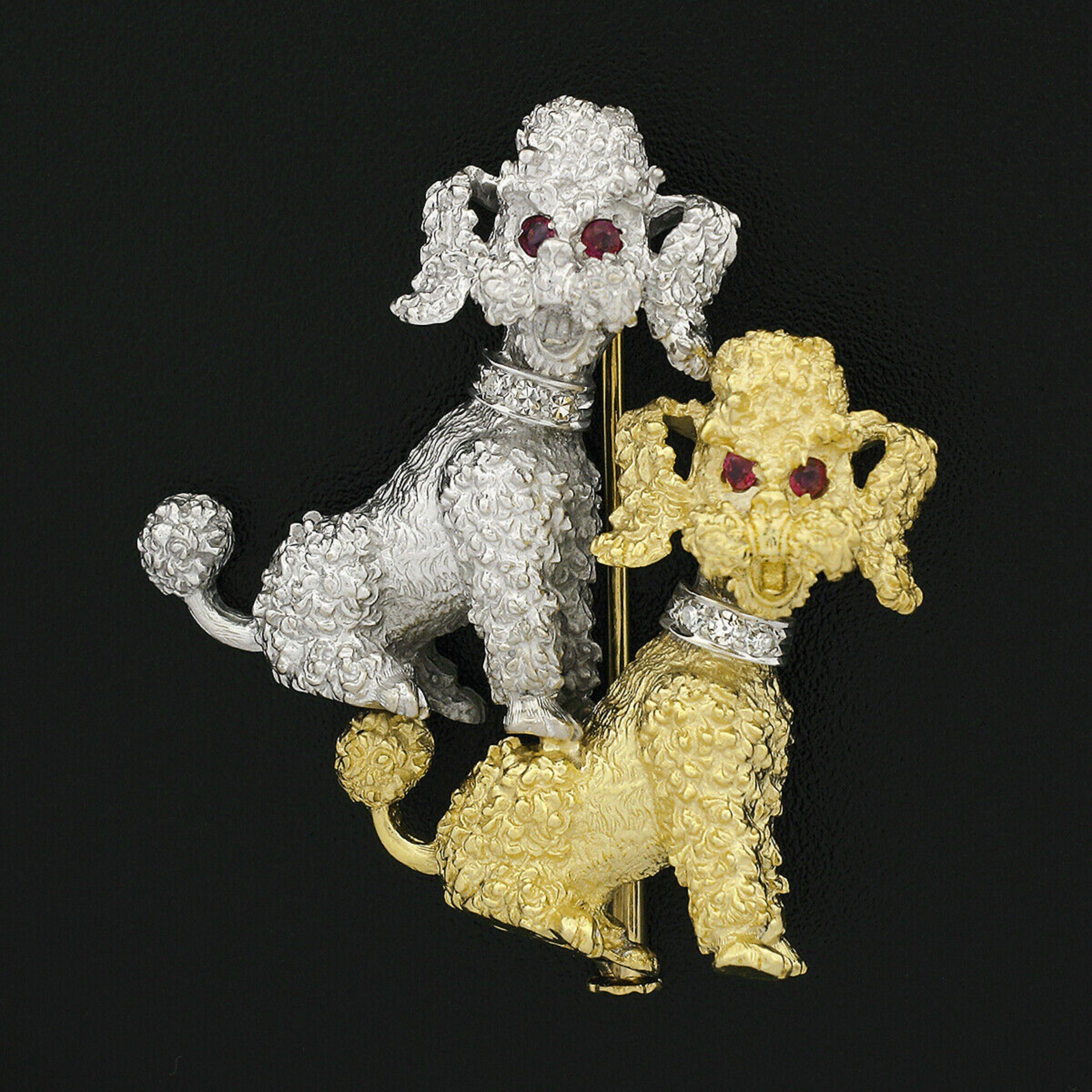 This outstanding vintage pin/brooch is crafted in solid 18k white and yellow gold and features two extremely detailed and textured poodle dogs. The adorable poodles are neatly set with fine rubies at their eyes, as well as gorgeous diamonds that