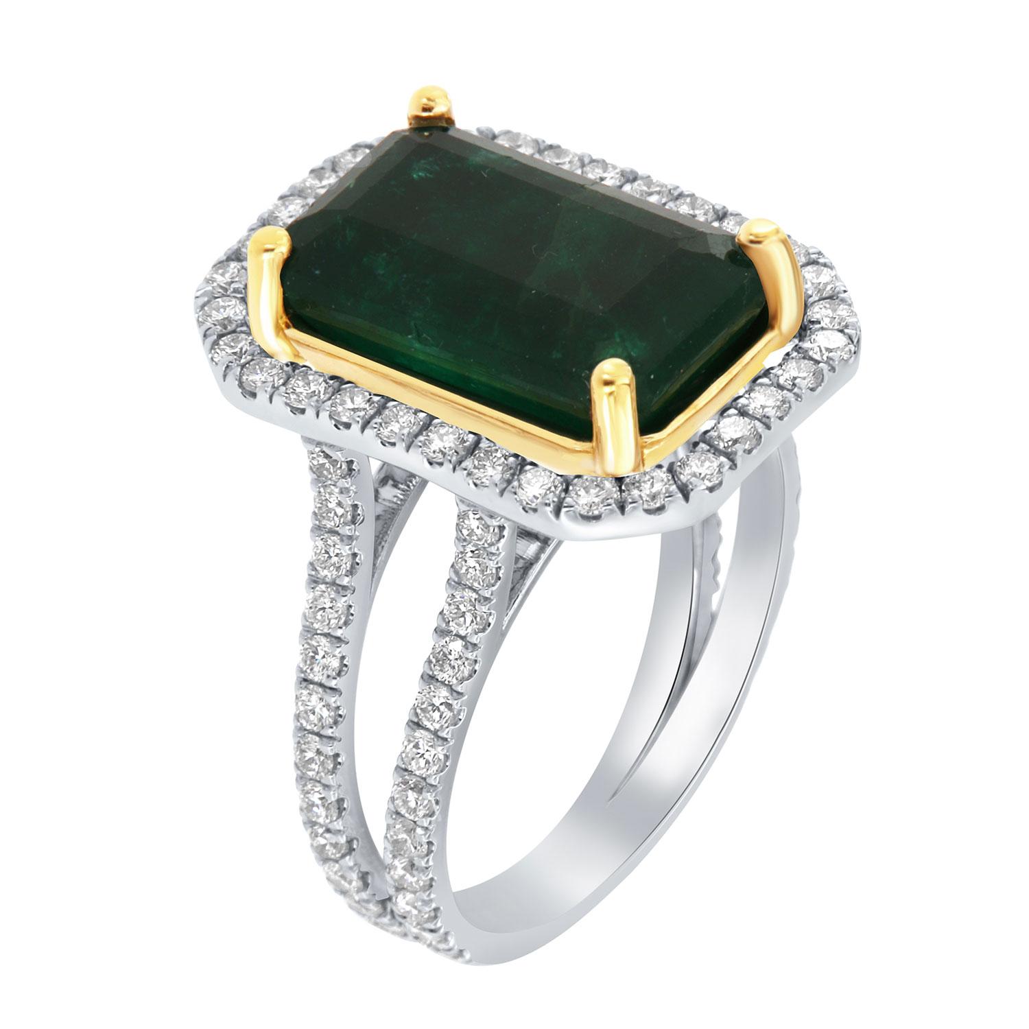 This 18k white and yellow gold ring features a 6.23 Carat Emerald cut Natural Green emerald from Zambia. It is encircled by a halo of brilliant round diamonds on a 6.00 mm wide split shank band. The diamonds are Micro-Prong set on 75% of the band. 