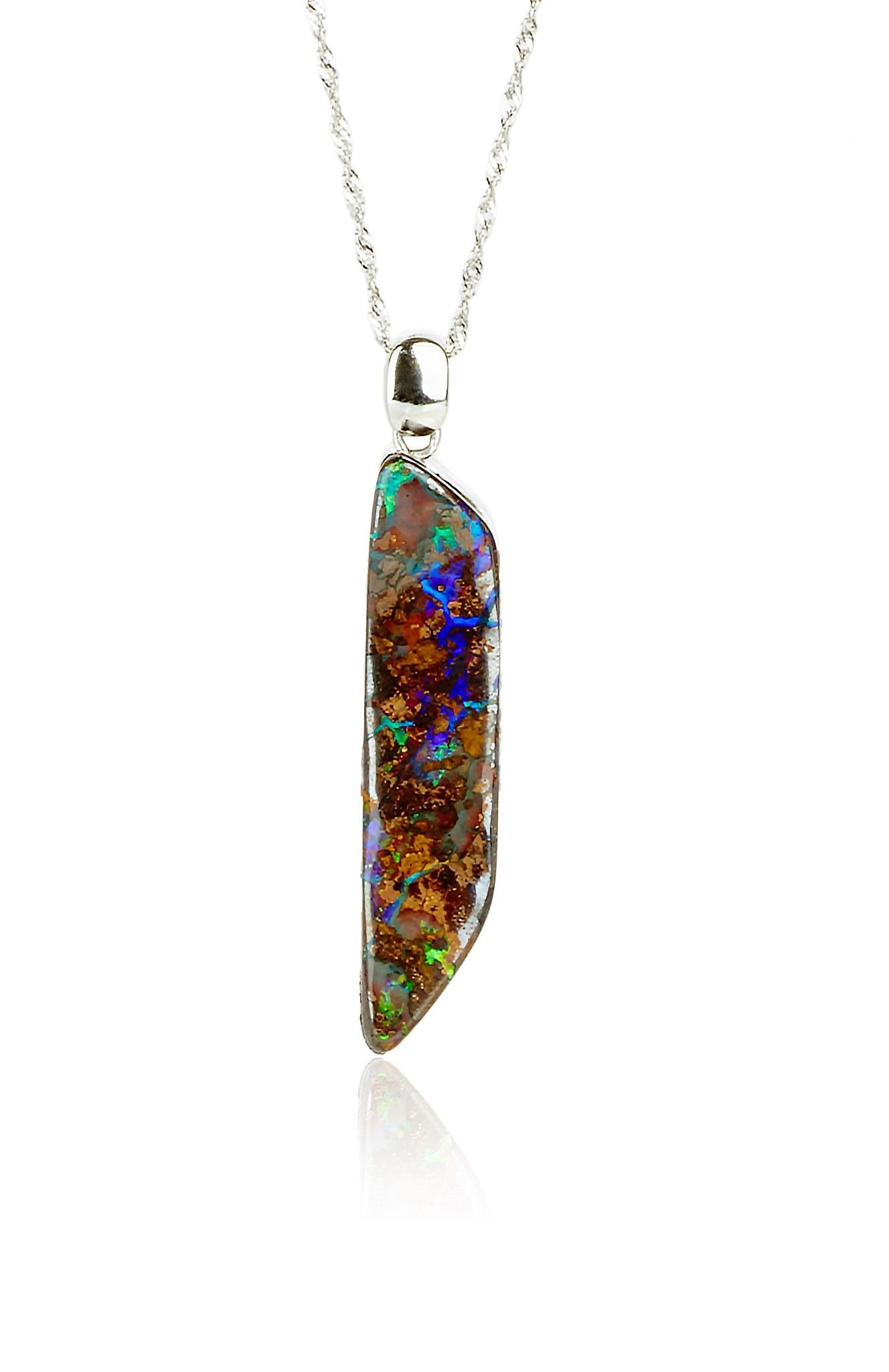This one of a kind pendant is from Lingjun's earlier creation, featuring a hand-carved boulder opal from Queensland, Australia, accent with diamonds, showcasing the gem's beauty from different perspectives on either side. 

This natural solid