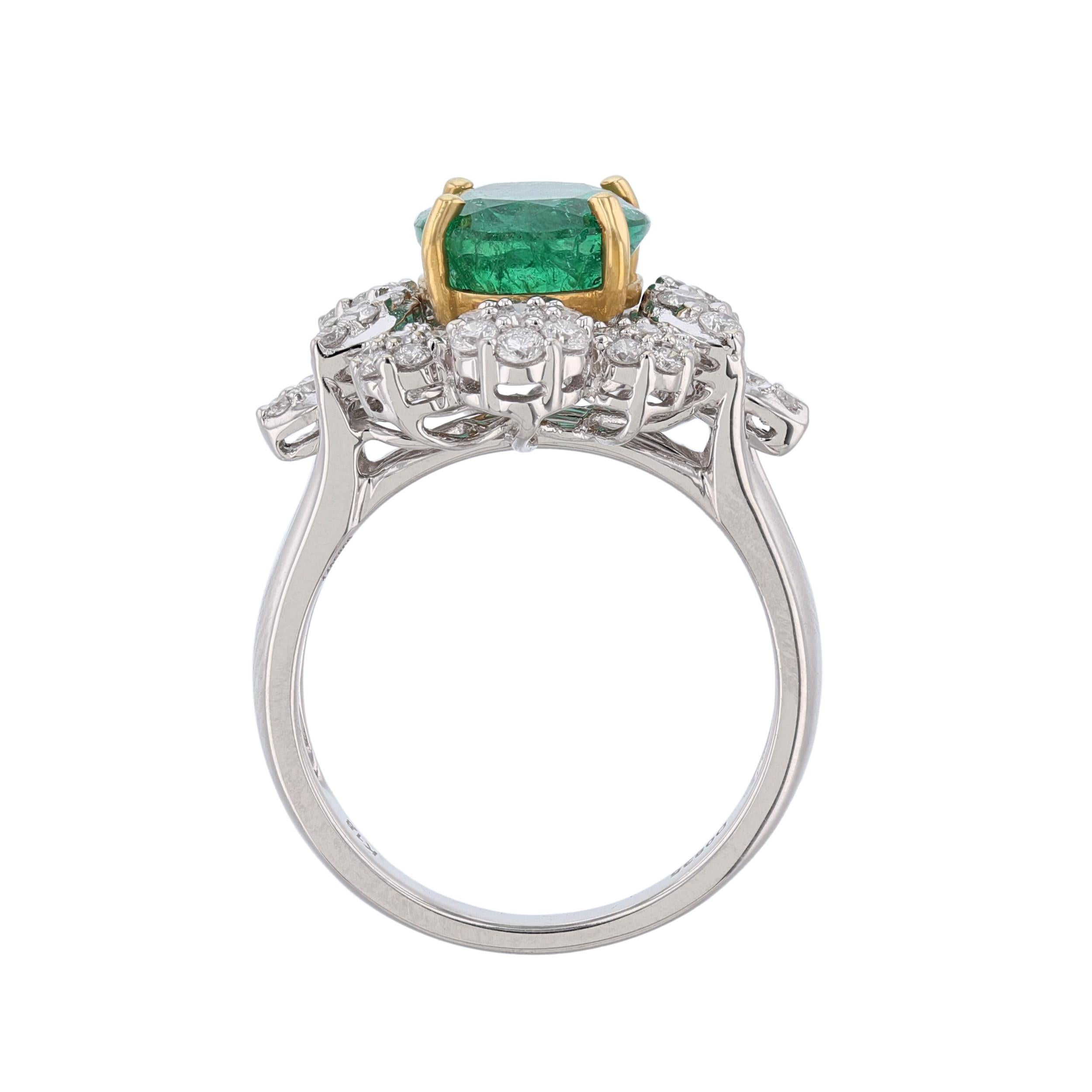 The ring is made in 18K white and yellow gold. It features a 3.05 carat oval shape emerald as the center stone. As well as 58 round cut diamonds weighing 0.83 carat. With a color grade of (H) and clarity grade of (SI1). All stones are prong set.