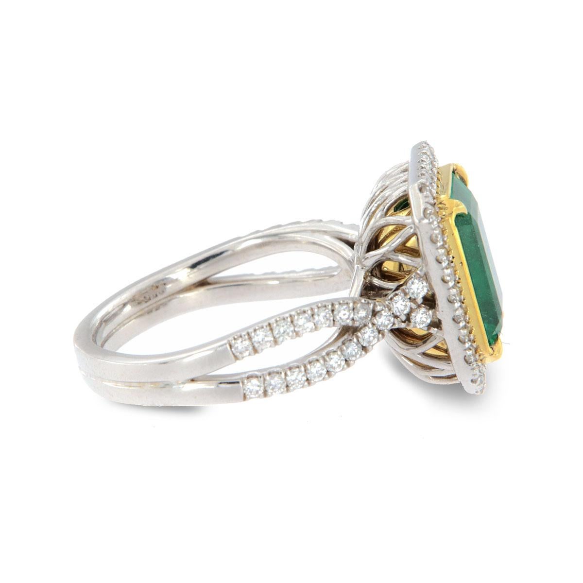 From our signature Gemstones collection of exquisite red carpet pieces, this handcrafted 18k Two-Tone gold ring is centering a 3.90 Carat of top quality Ethiopian rectangular green emerald in premium luster encircled by a halo of brilliant round