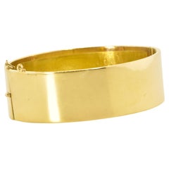 18K Wide Impressive Bangle Bracelet which opens with a high polish, Modern.
