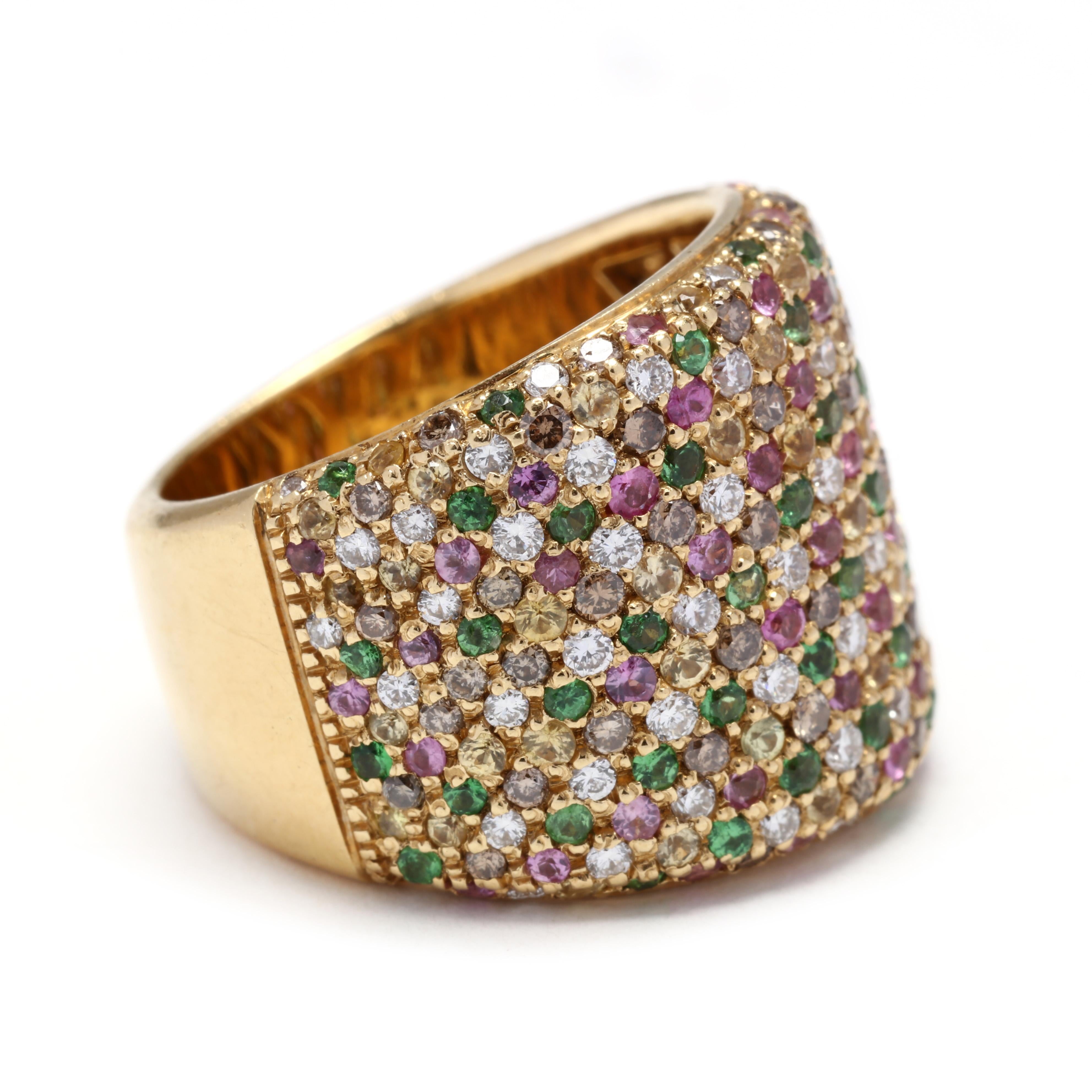 An 18 karat yellow gold diamond and mult gemstone pavé band. This band features a wide tapered design with pavé set round cut stones including diamonds, light brown diamonds, tsavorite garnets, pink sapphires and yellow sapphires.

Stones:

-
