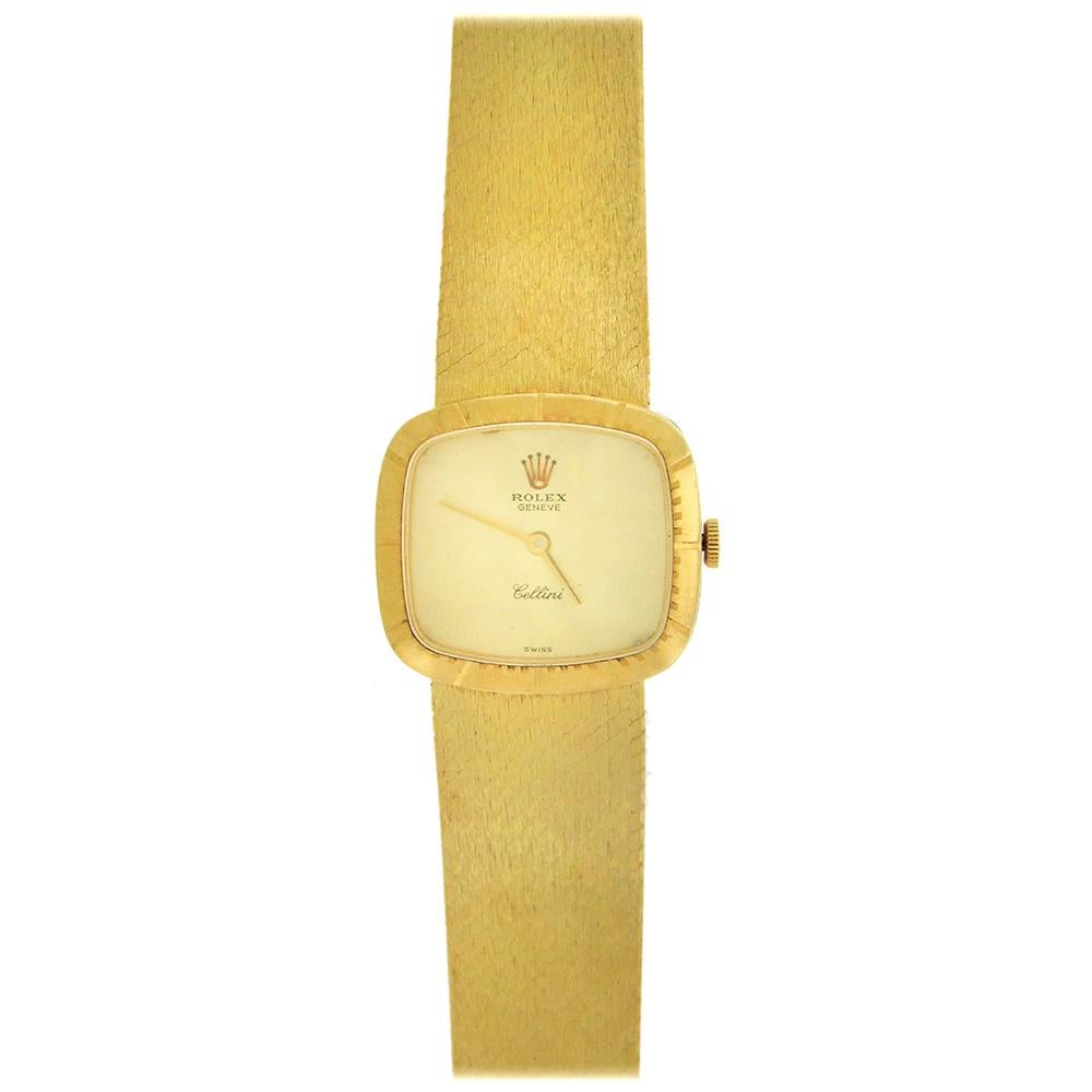 18K gold women's Rolex, Genève, Cellini, Ref. 4082, m circa 1973, is a fine, cushion-shaped, 18k yellow gold lady's wristwatch with an integrated 18K yellow gold textured Rolex mesh bracelet. The 24mm x 22mm case has a  graduated bezel, snap-on case