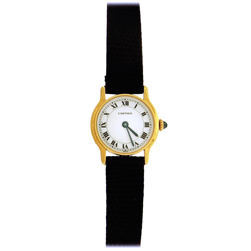 18K yellow gold Cartier, made in the 1980's, has a 29mm case, signed Cartier Paris, white dial with painted black radial Roman numerals, secret signature at 7, blued steel sword hands, manual wind movement warrantied by Aaron Faber for 1 year.  Back