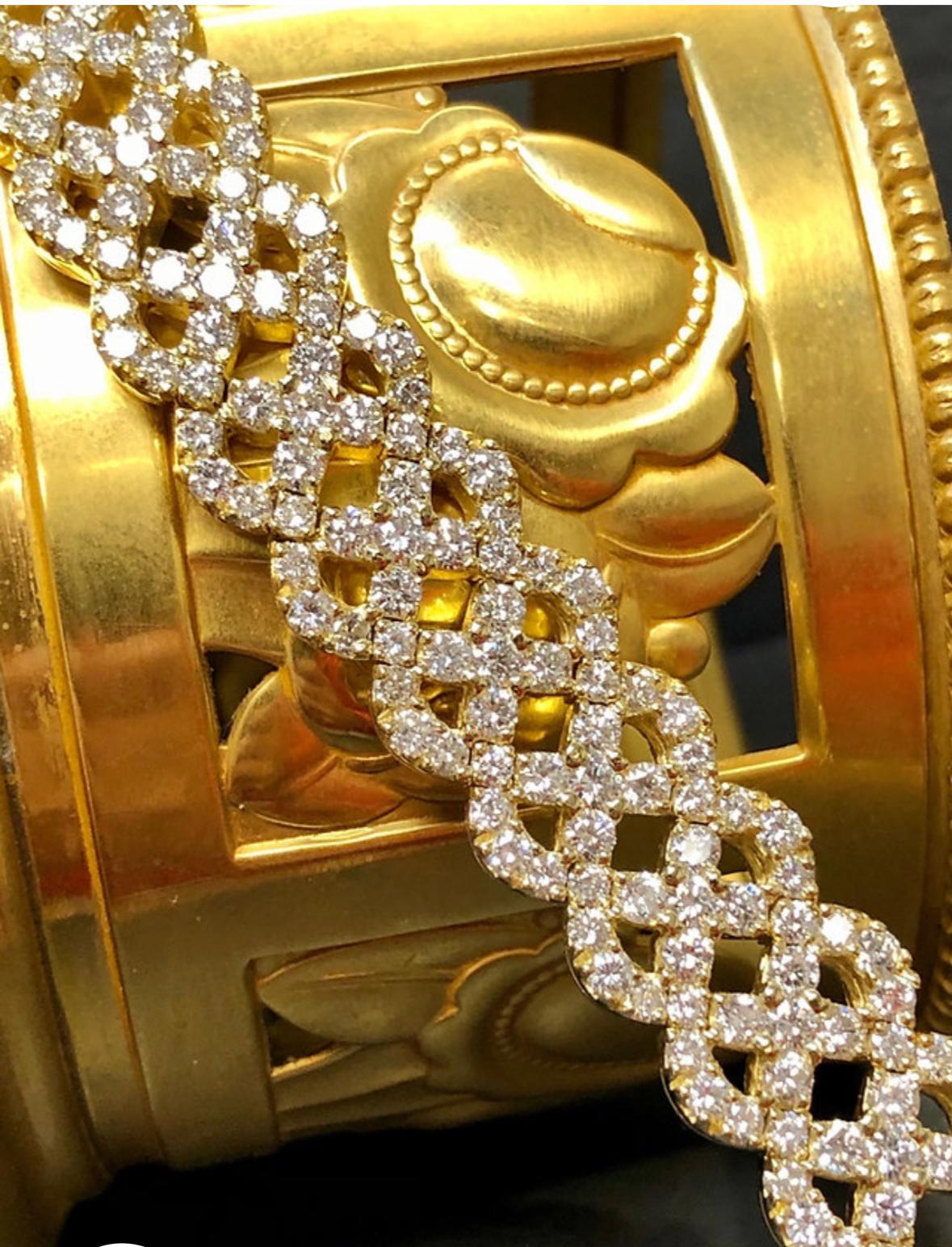 A fabulously made bracelet done in 18K yellow gold set with approximately 12.90cttw in F-G color Vs1-2 clarity diamonds. Very substantial piece.

Dimensions/Weight
6.80” long by .50” wide. Weighs 28dwt.

Condition
All stones are secure and