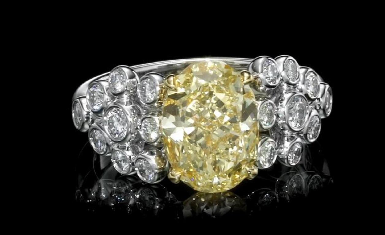 Presenting an exquisite jewelry masterpiece, behold the Oval Shape Diamond. Weighing 3.02 carats, this captivating diamond showcases a stunning Fancy Yellow color grade, emanating an enchanting hue that captures attention. Certified as VS2 by the