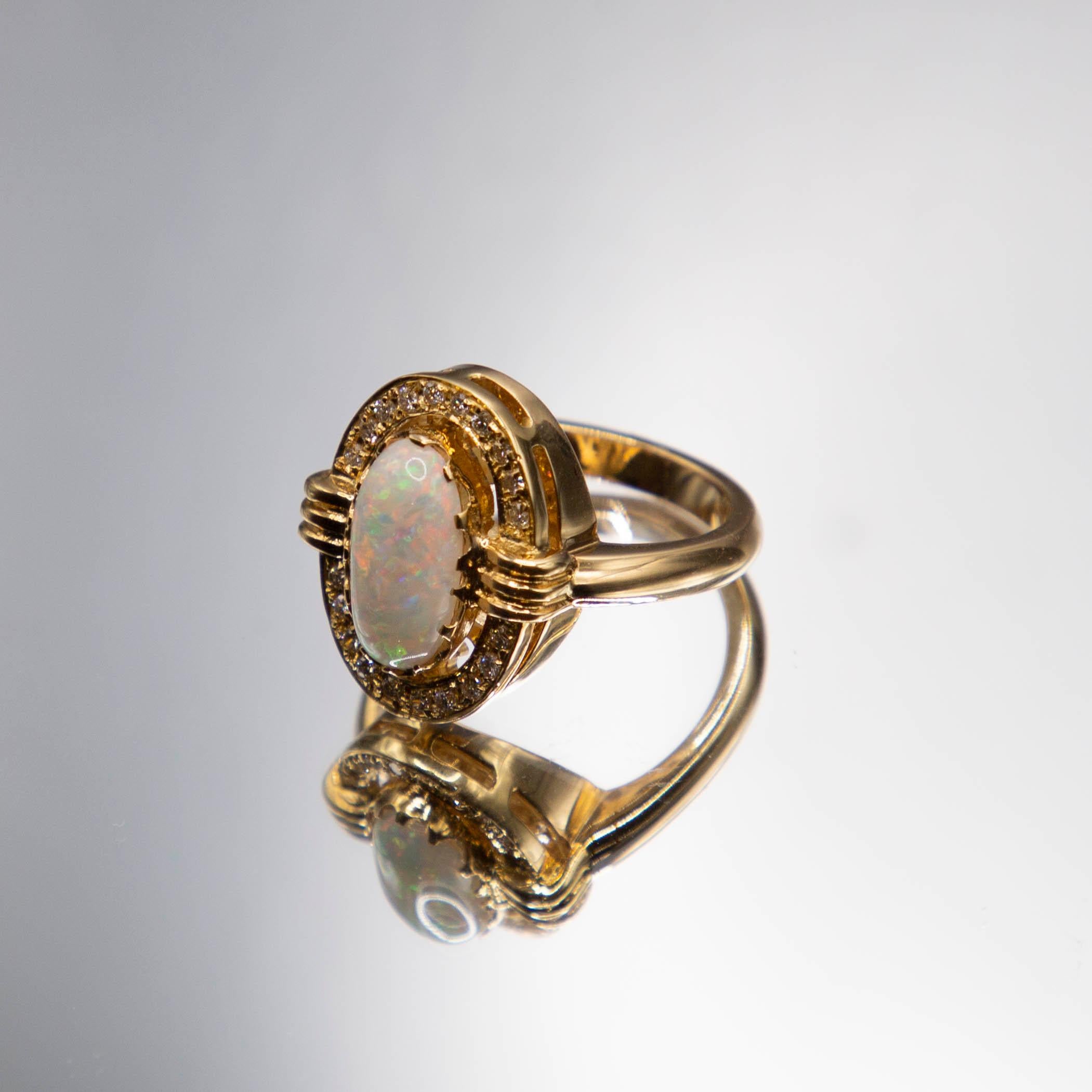 A one -of-a-kind 18k yellow gold ring features a highly sought- after Lightning Ridge Red Flash opal at just under 2 carats. The mesmerizing and truly intense play of color predominates in the hot colors then rolls into stunning cool blues and