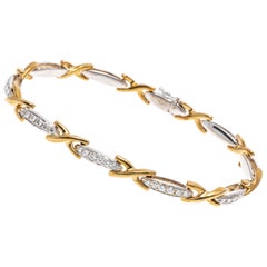 Bracciale a "X" in oro giallo e bianco 18K e diamanti, App. 0,32 TCW