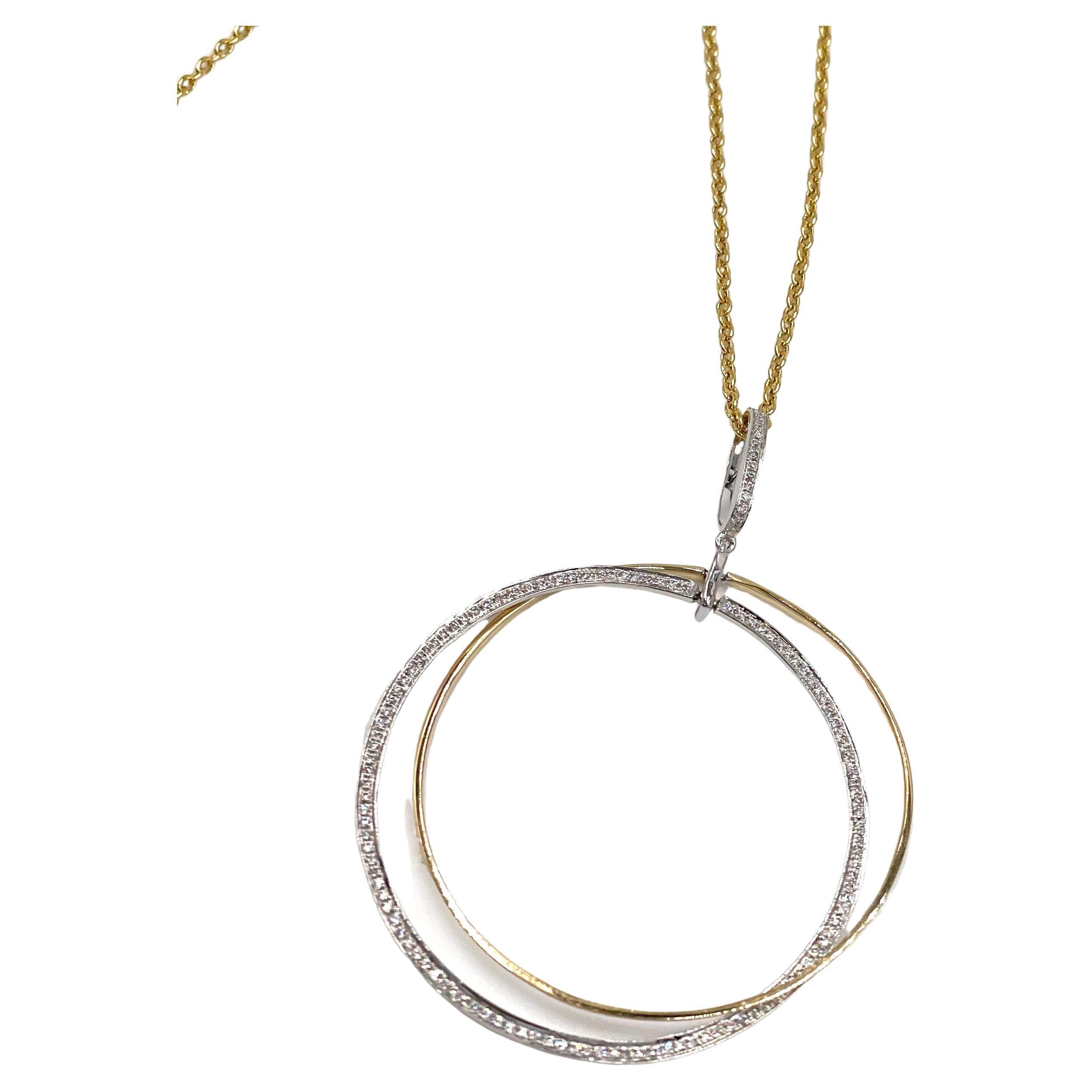 A spin on a classic circle necklace.  This 18K white and yellow gold circle pendant necklace is beautifully composed with two interlocking circles and furnished with round diamonds weighing a total of 0.37 carat.

- Diamonds are G color, VS