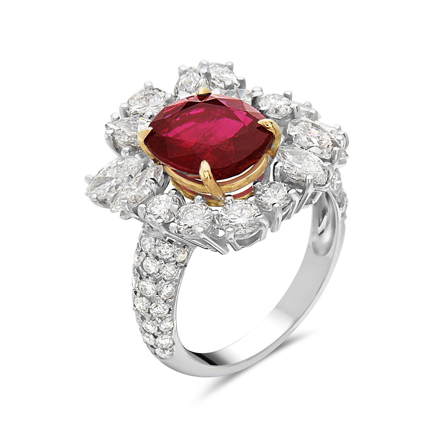 This cocktail ring features 3.25 carats of G-H VS-SI pear, marquise, and round diamonds, and 2.82 carats of red moderately strong ruby set in 18K white and yellow gold. With 2 brilliant pears, 8 marquise brilliant, and 39 round brilliant cut