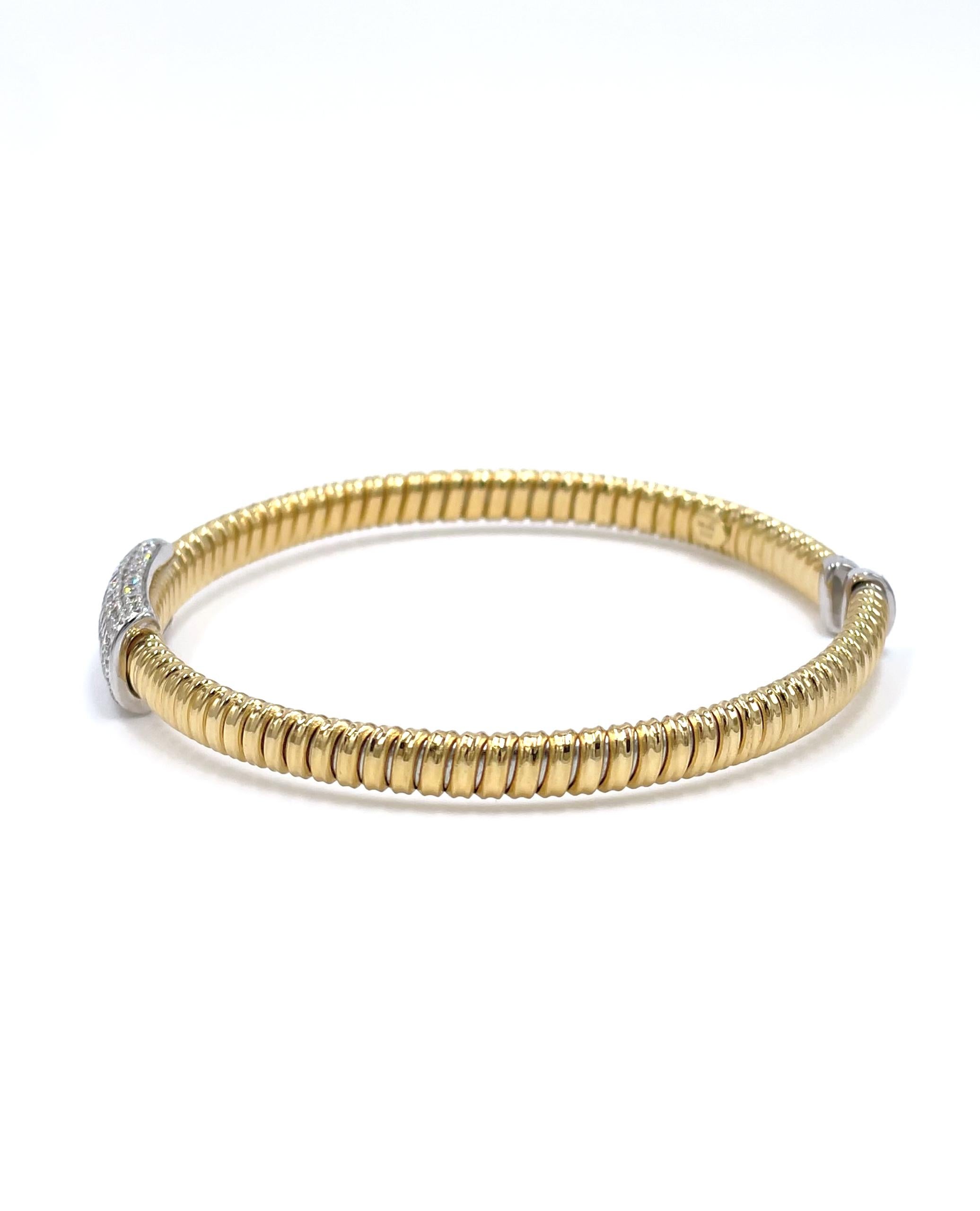 18K yellow and white gold open bangle with ribbed detail and round brilliant-cut pave set diamonds weighing 0.87 carats total: G color, VS2/SI1 clarity.

- Can accommodate 6.5-7.5 inch wrist