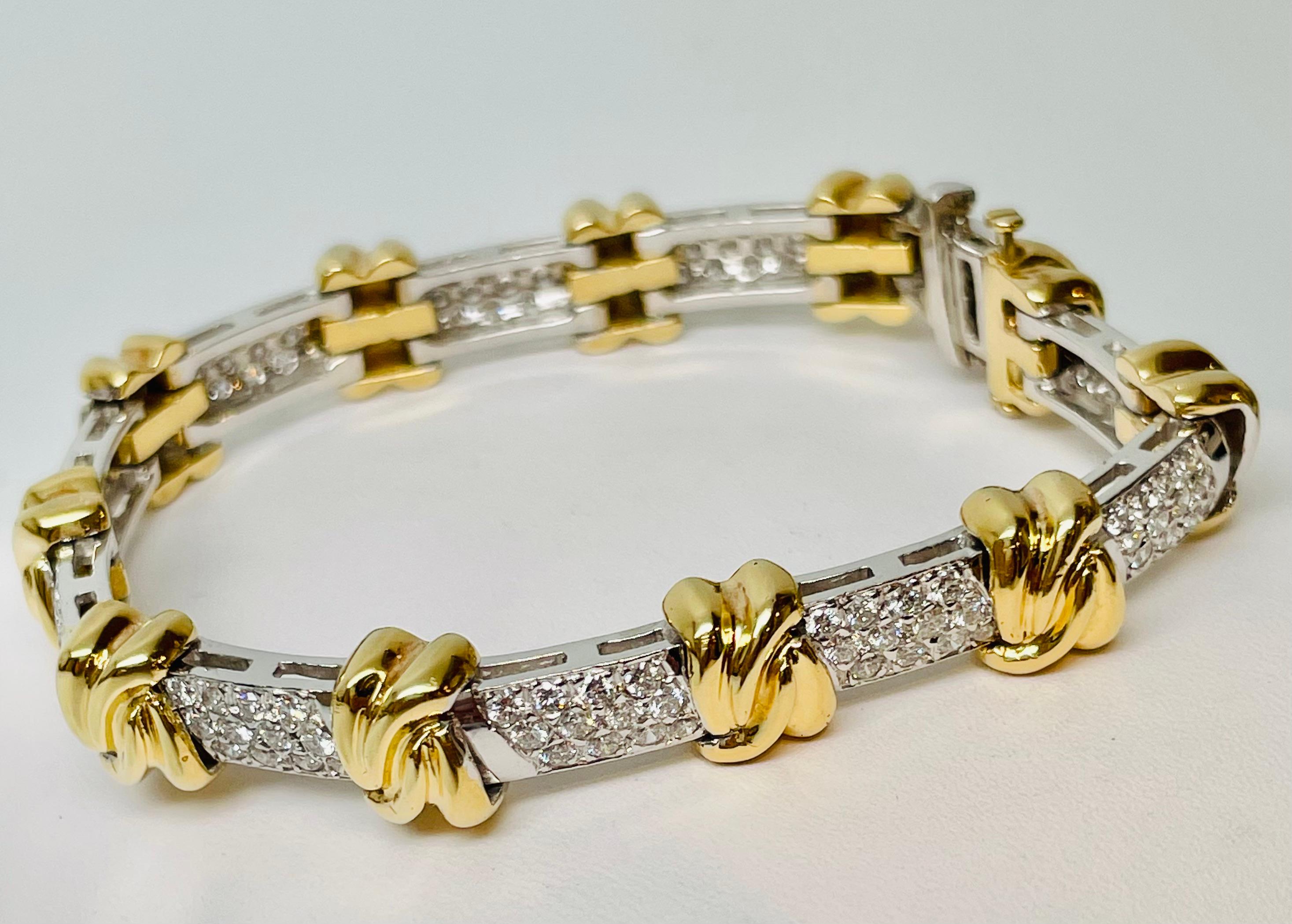 Fabulous 18kt Yellow and White Gold classic, chunky diamond bracelet with bright white diamonds. Important piece with lots of sparkle! Handcrafted beautiful design of pave diamonds separated by yellow gold knots.  It is set with 133 Round Brilliant