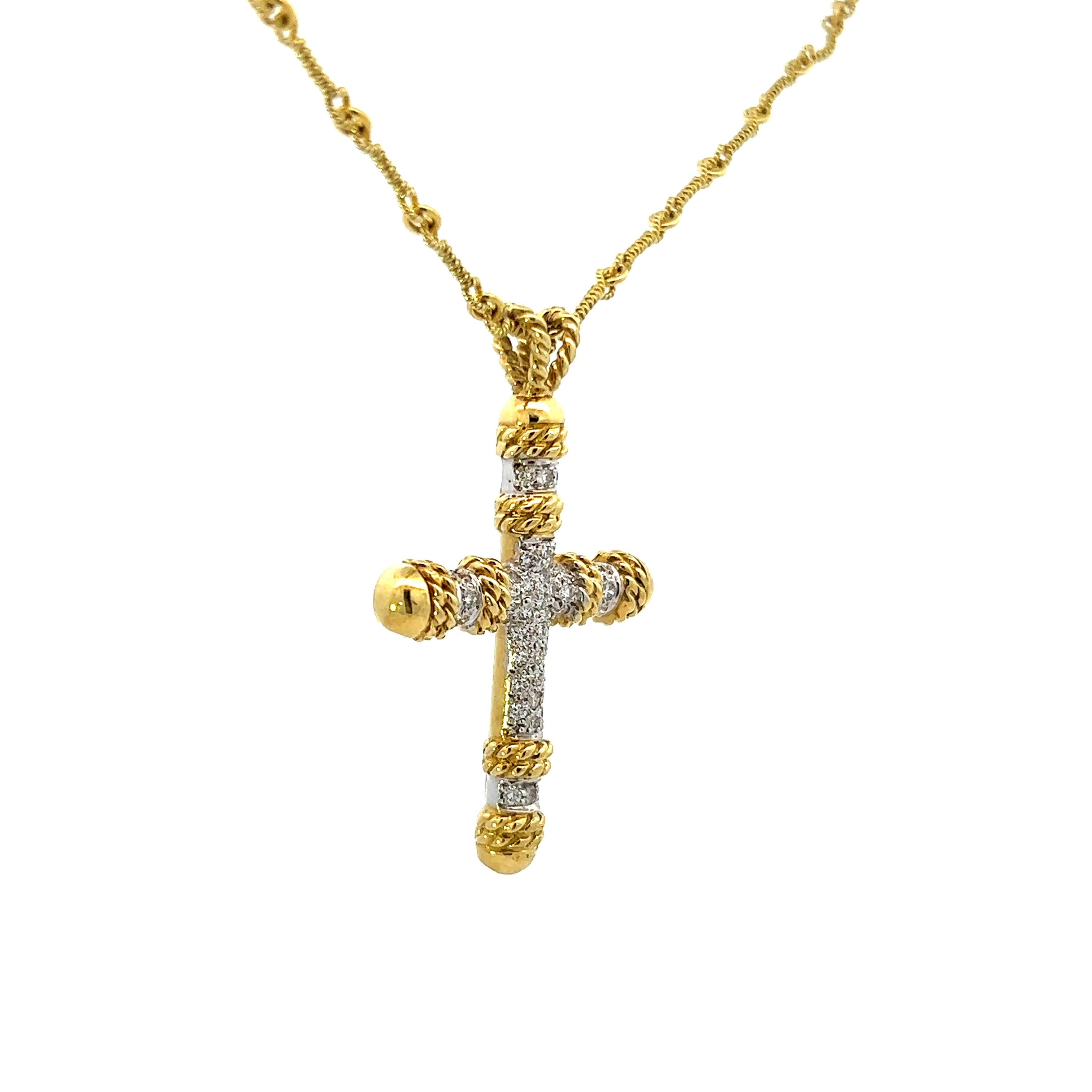 This gorgeous necklace features a 18k yellow and white gold diamond cross pendant on a unique 18k yellow gold handmade chain. This necklace carries a beautiful rope design that can be seen in the pendant as well as the handmade chain. This unique