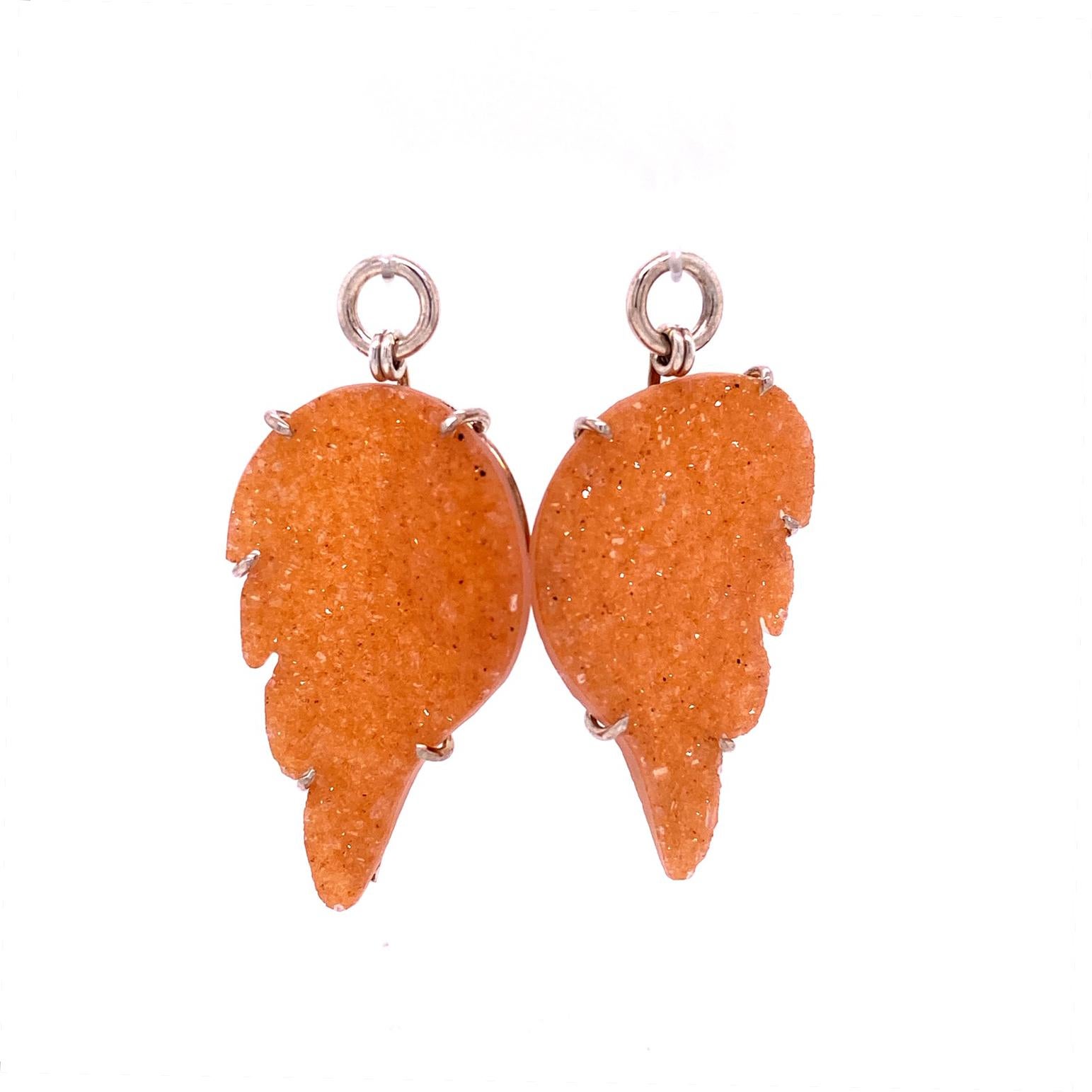 A pair of reversible 18k yellow and white gold huggie hoops, with a pair of peach druzy wing jackets set in sterling silver. These earrings were made and designed by llyn strong.
Items sold separately upon request.
