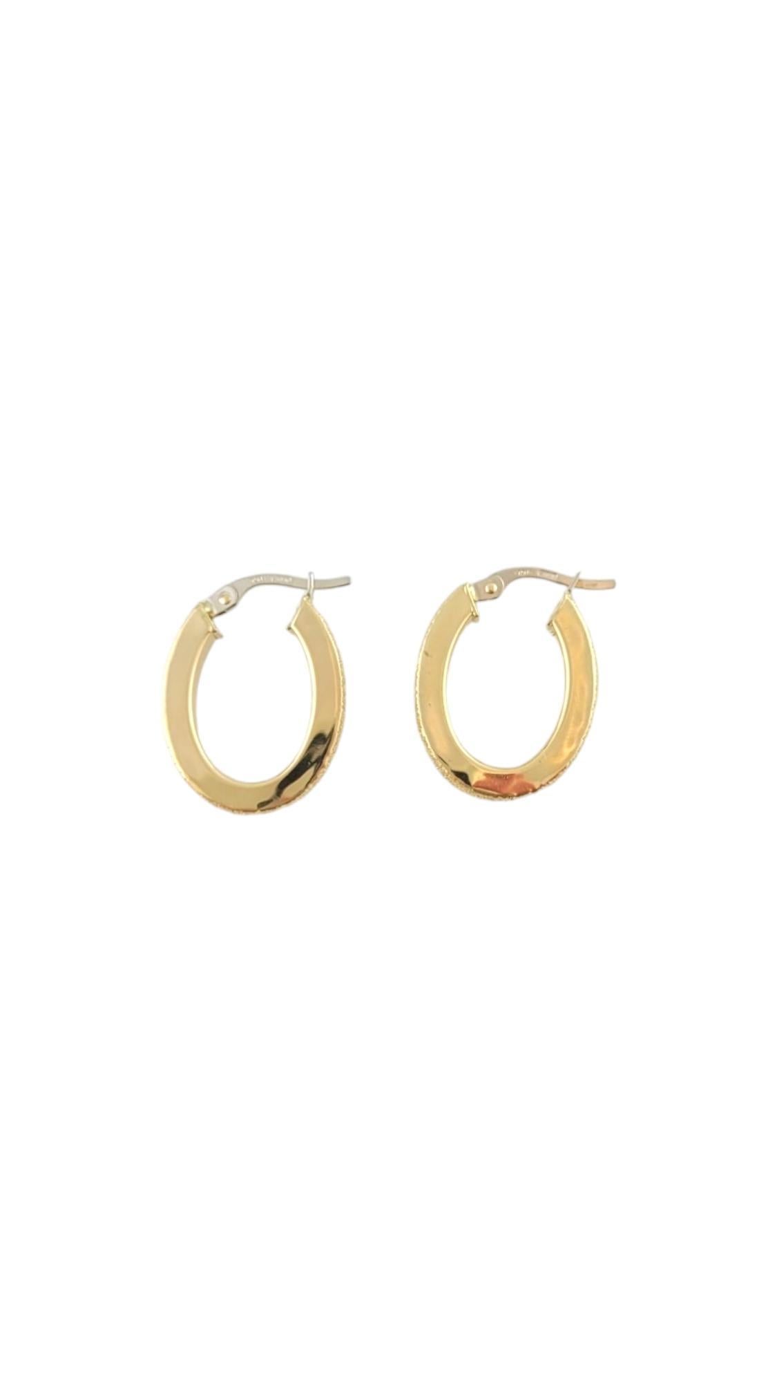 Vintage 18 Karat Yellow and White Gold Hoop Earrings-

These gorgeous gold hoops feature a sparkling textured edge set in yellow gold with white gold clasps. 

Size: 22.4 mm x 3.2 mm x 3.3 mm. 

Stamped: 750 539 AR

Weight: 2.3 dwt./ 3.6 gr. 

Very