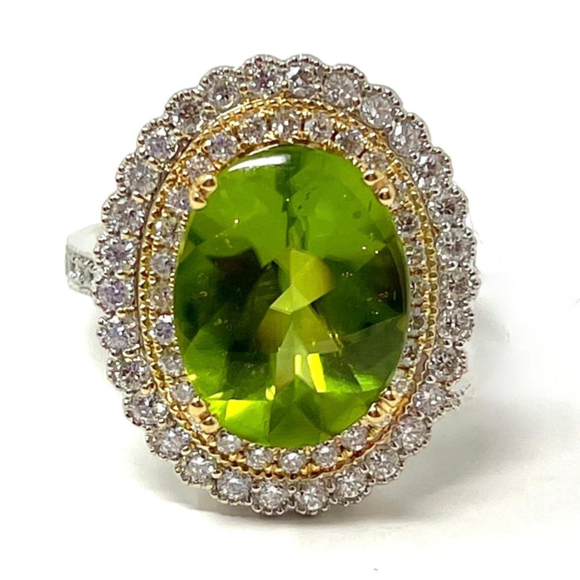 A strikingly vivid green peridot and diamond cocktail ring that would be a great gift for the August baby in your life. The unique buff cut stone is beautifully set off by two rings of diamonds set in yellow and white gold.

The peridot is